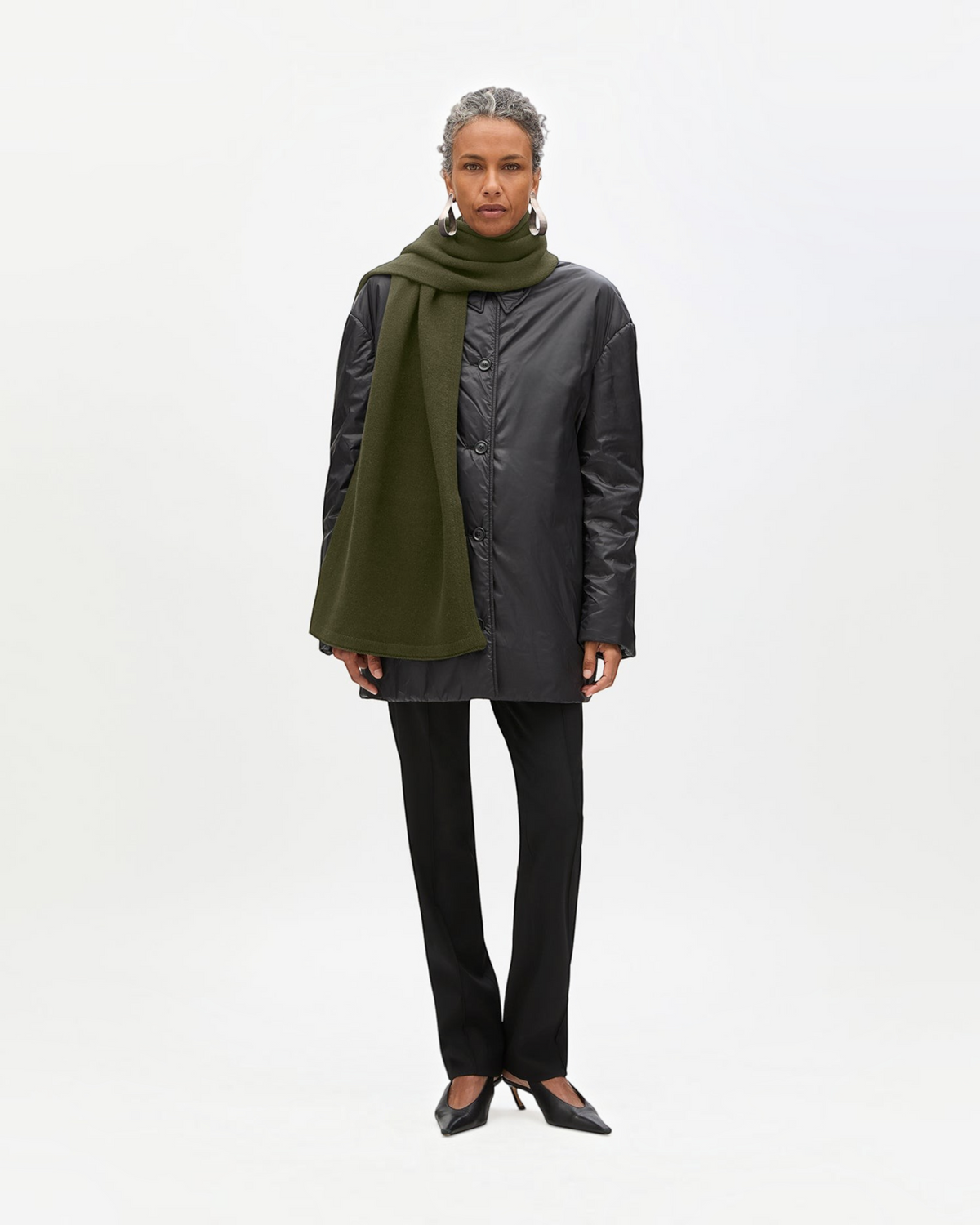 Weldun moss green recycled cashmere shawl scarf worn by a model in a black jacket and trousers