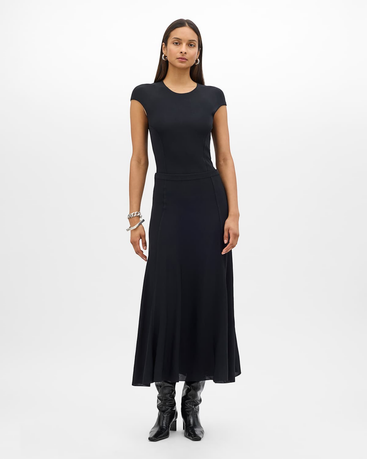 Weldun black seamed fitted jersey top worn by a model with a matching skirt and black boots