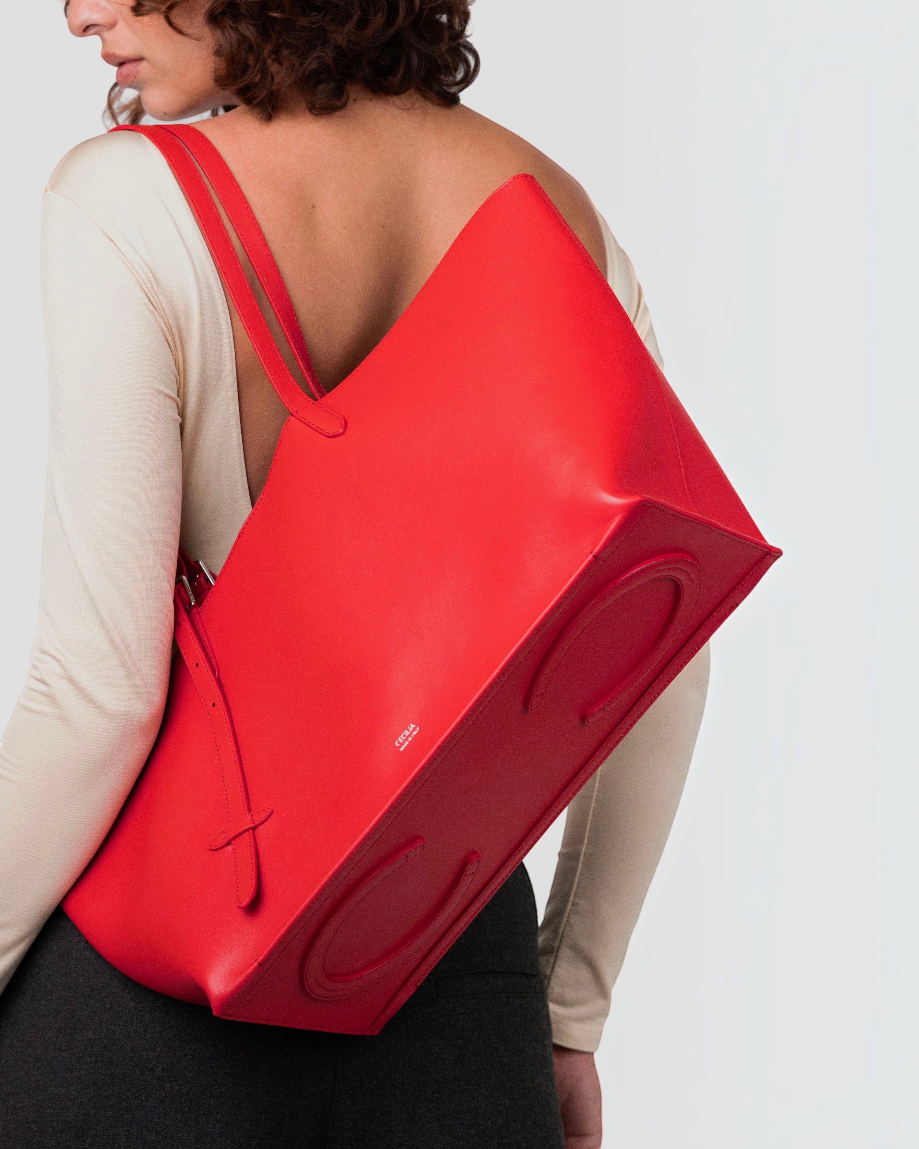 Weldun Leonora Day soft red Italian nappa leather tote bag with adjustable stirrup buckle straps worn on shoulder