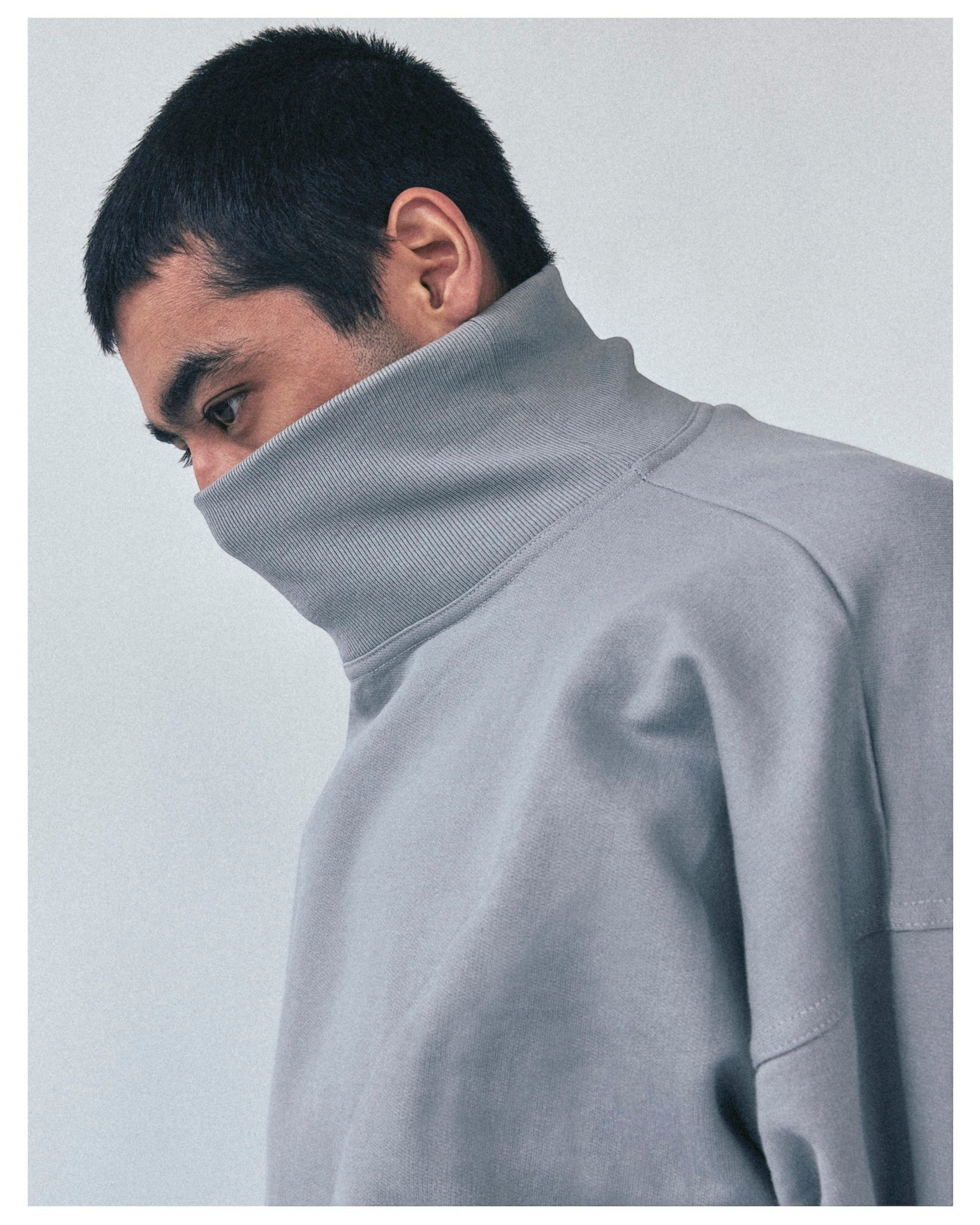 Weldun grey organic cotton high neck sweatshirt with a boxy fit and ribbed collar worn by a man in profile