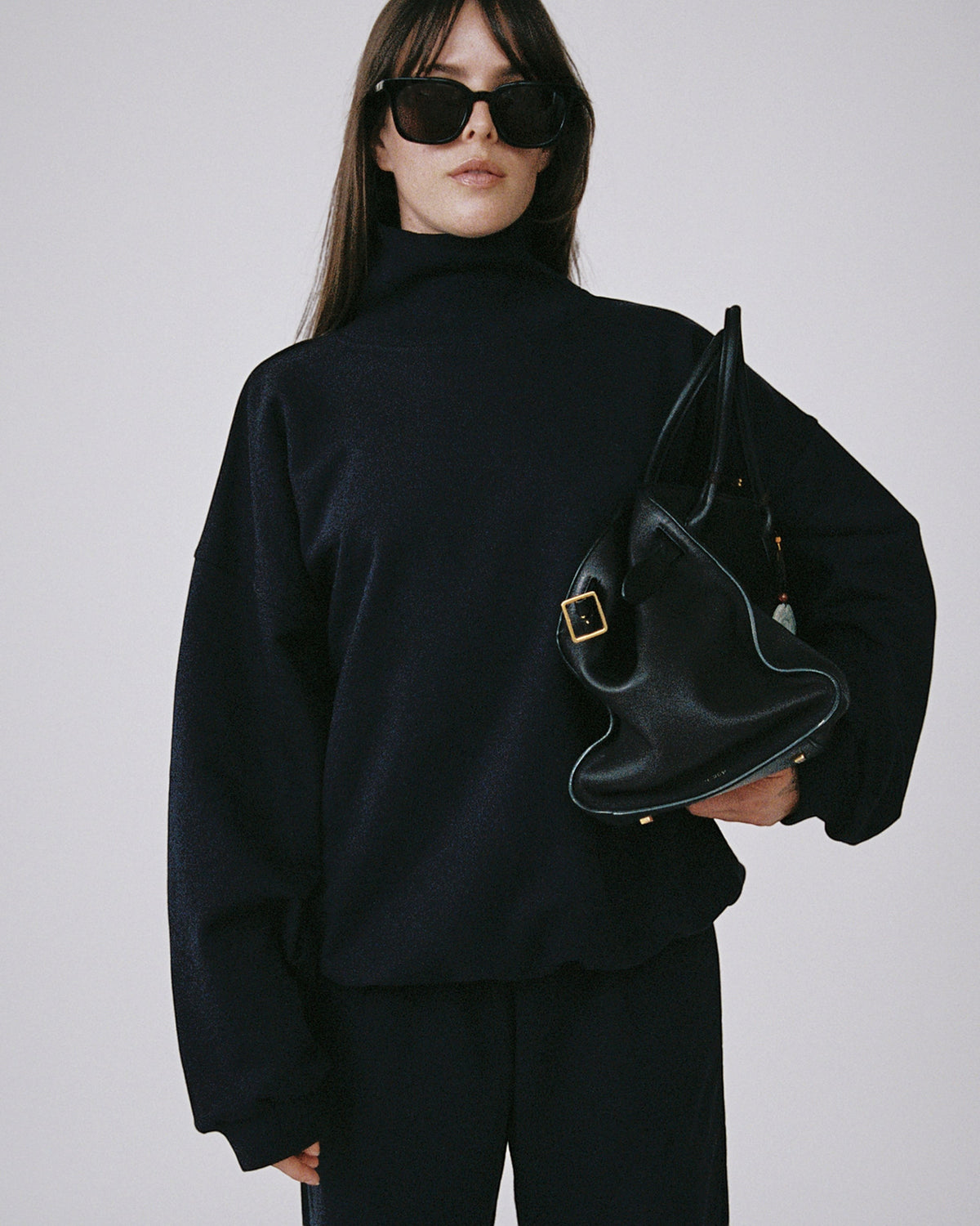 Weldun navy organic cotton high neck sweatshirt with a relaxed boxy fit worn by a model with black sunglasses