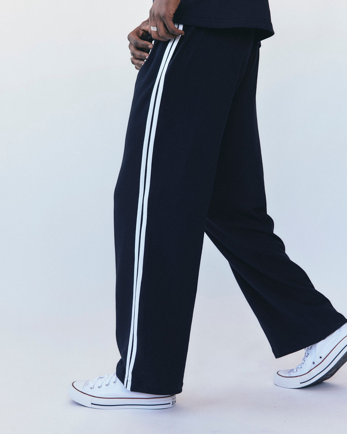 Weldun navy cotton terry track pants with white side stripes worn by a model in a relaxed fit