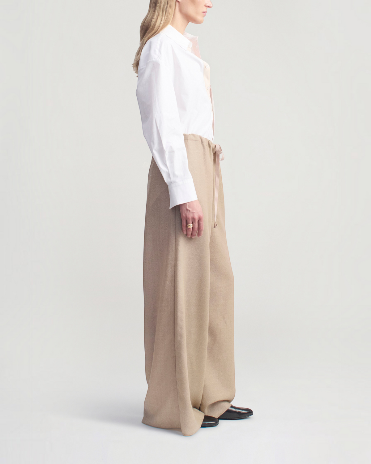 Weldun Cairo wide leg pants in taupe featherweight wool with an adjustable drawstring waist, side view on a model.