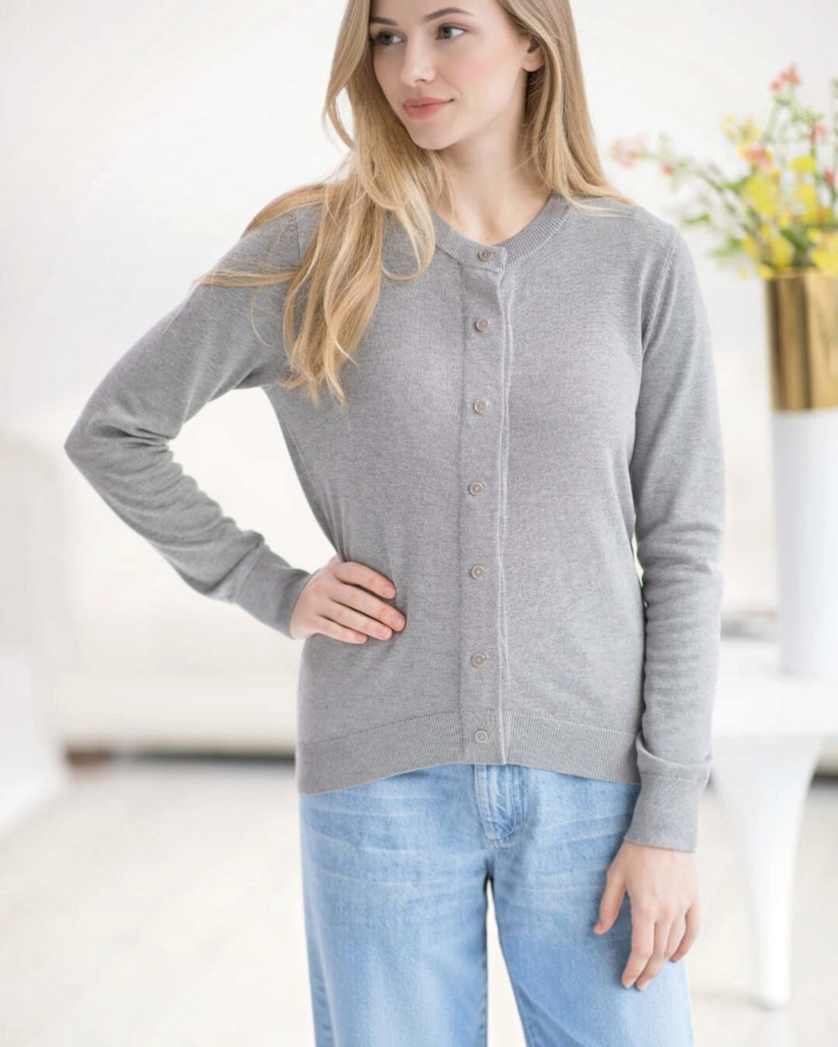Weldun grey adaptive knit cardigan with magnetic front closures worn by a blonde model with light blue jeans