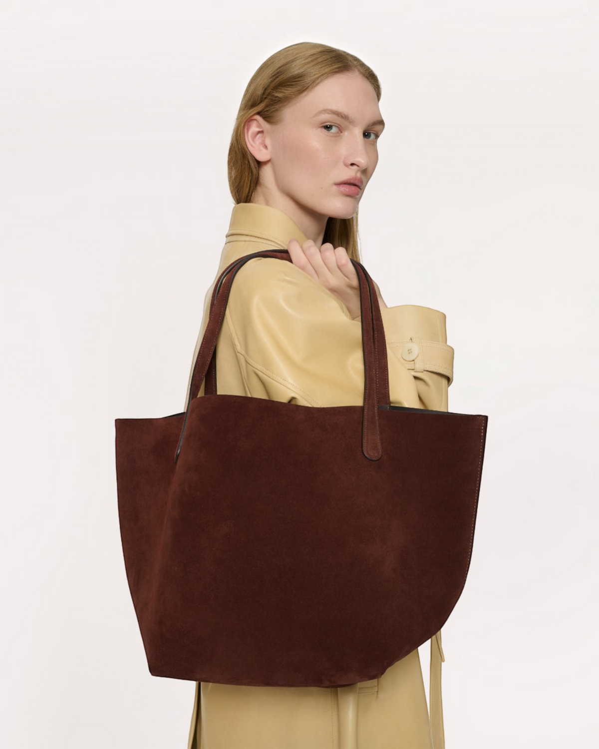 Weldun Mansur Gavriel Everyday Soft Tote in chocolate brown Italian suede leather carried over a model's shoulder.