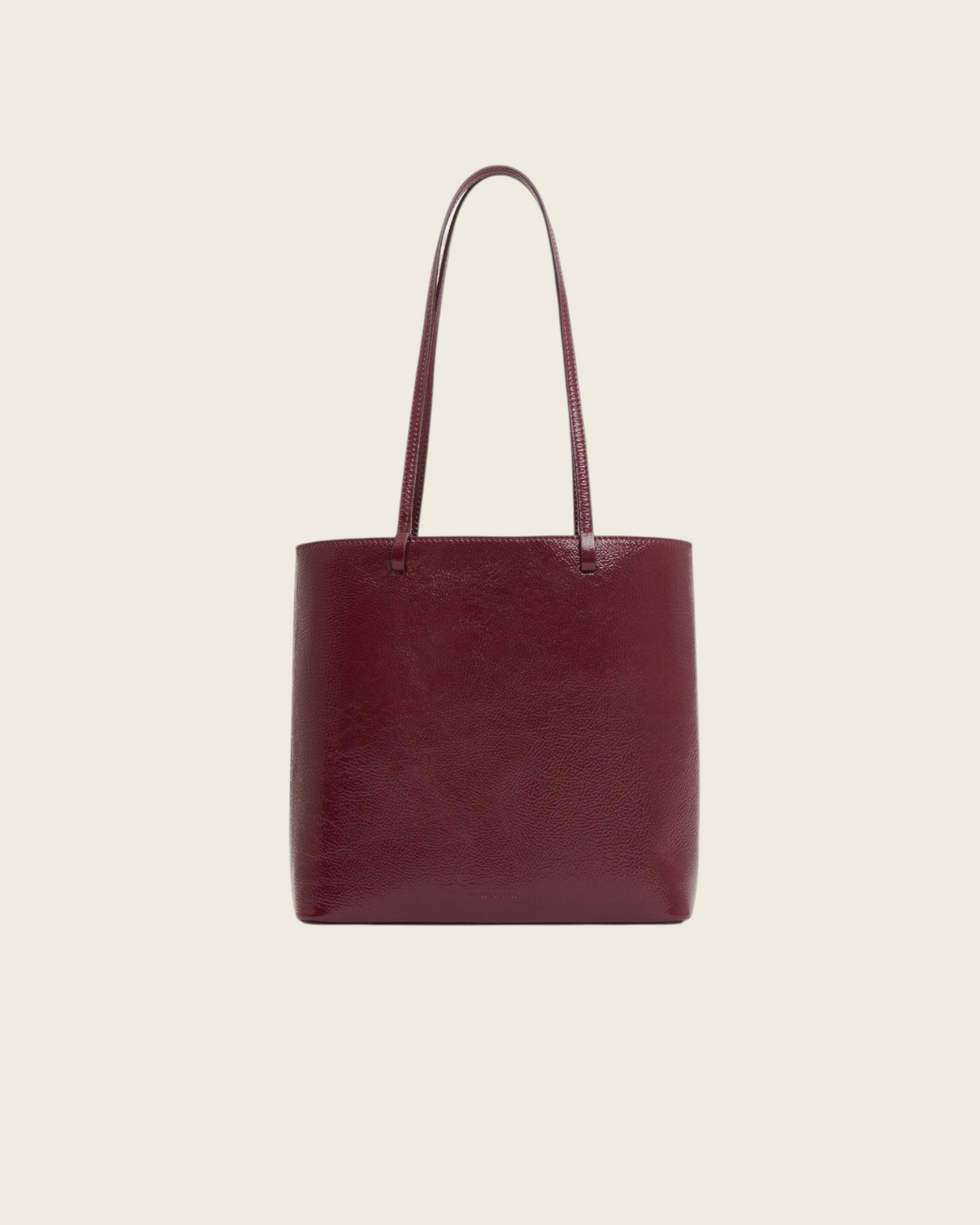 Weldun Filo Tote in claret red laminated Italian leather with a structured silhouette and long shoulder straps.