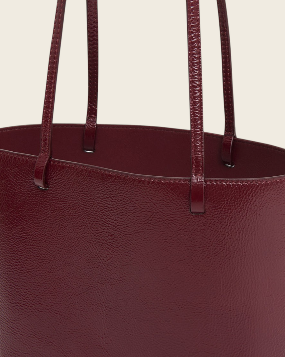 Weldun Mansur Gavriel Filo Tote in claret red laminated Italian naplak leather with structured shoulder straps.