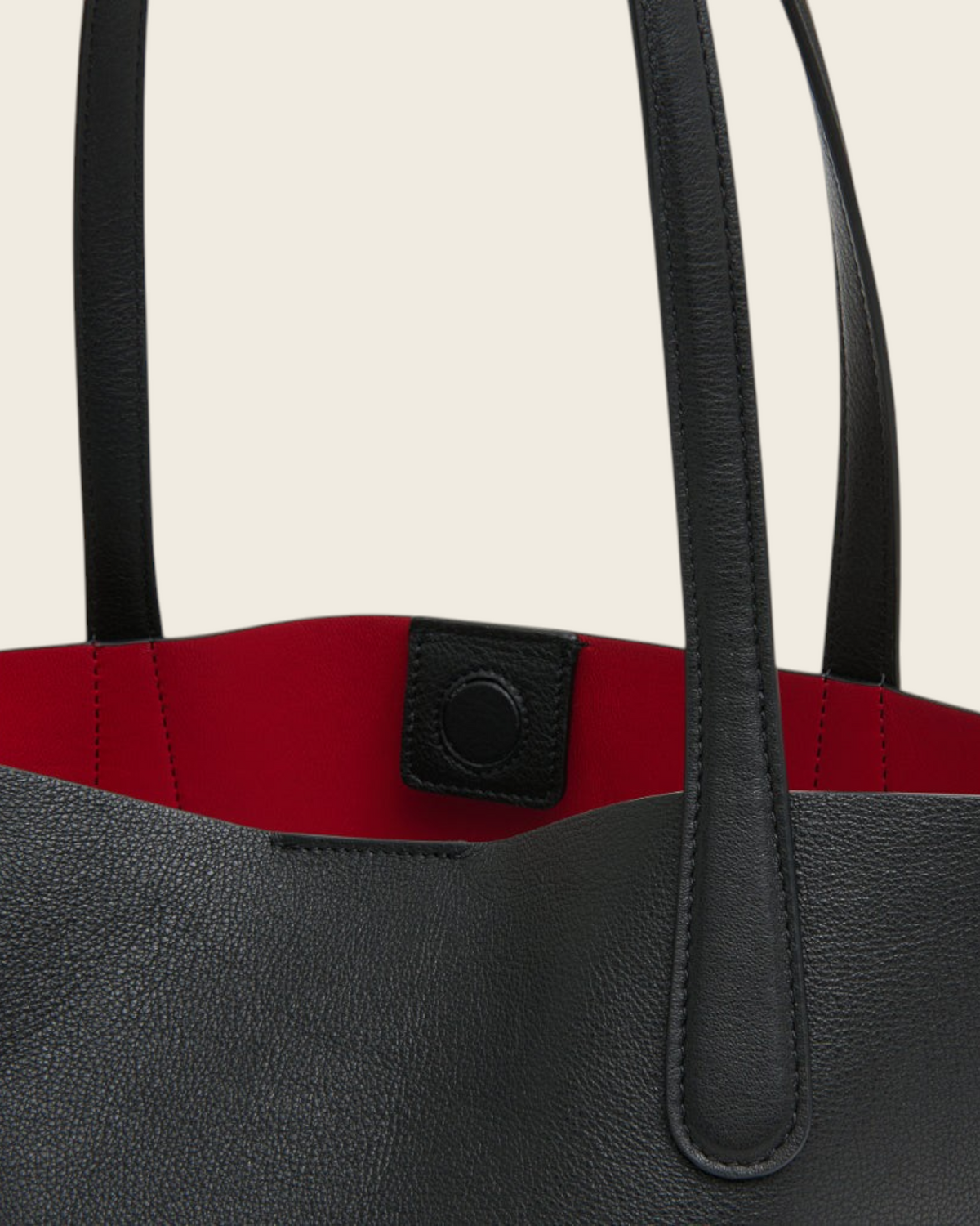 Weldun Mansur Gavriel small everyday soft tote in black calf leather with a vibrant red interior and Bombay handles.