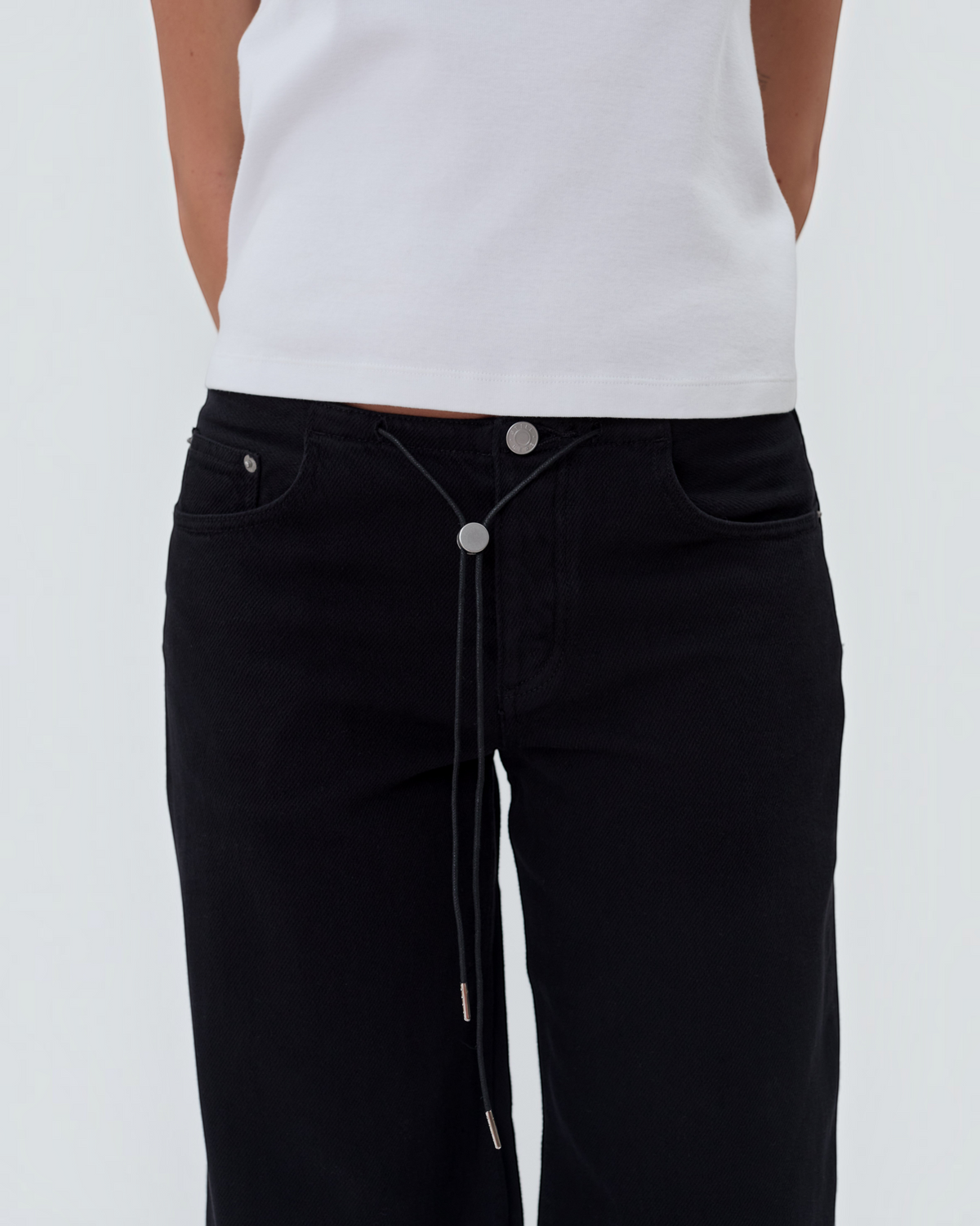 Weldun Still Here Cool Jean in black with an elastic waistband, adjustable drawstring toggle, and metal hardware.