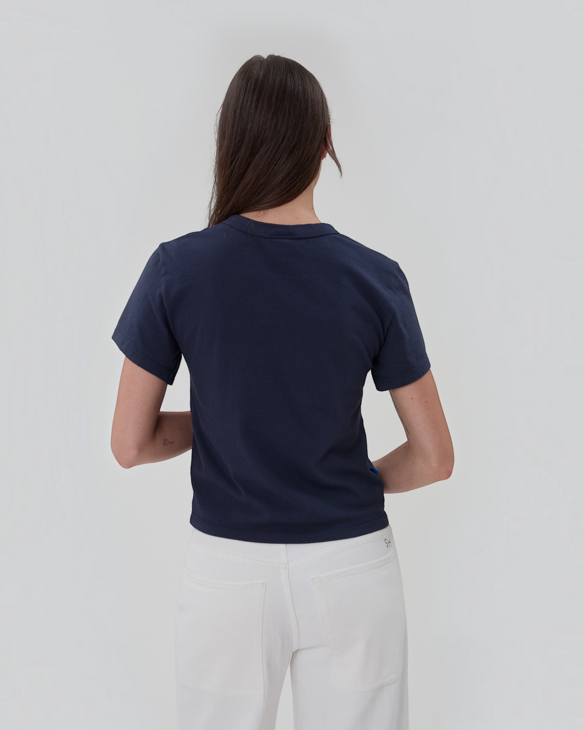 Weldun Still Here navy blue short sleeve cotton henley shirt worn by a model, back view.