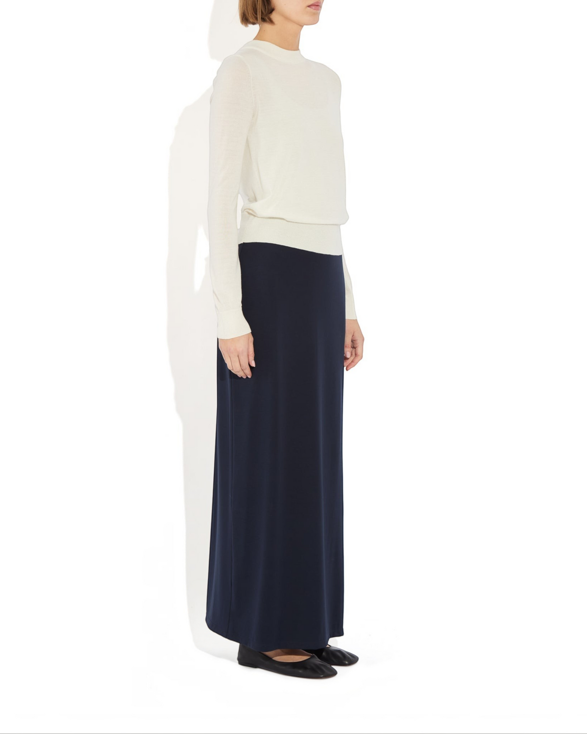 Weldun Ashley Skirt in navy blue, a minimal column-style pull-on skirt in soft stretch fabric with a side slit.