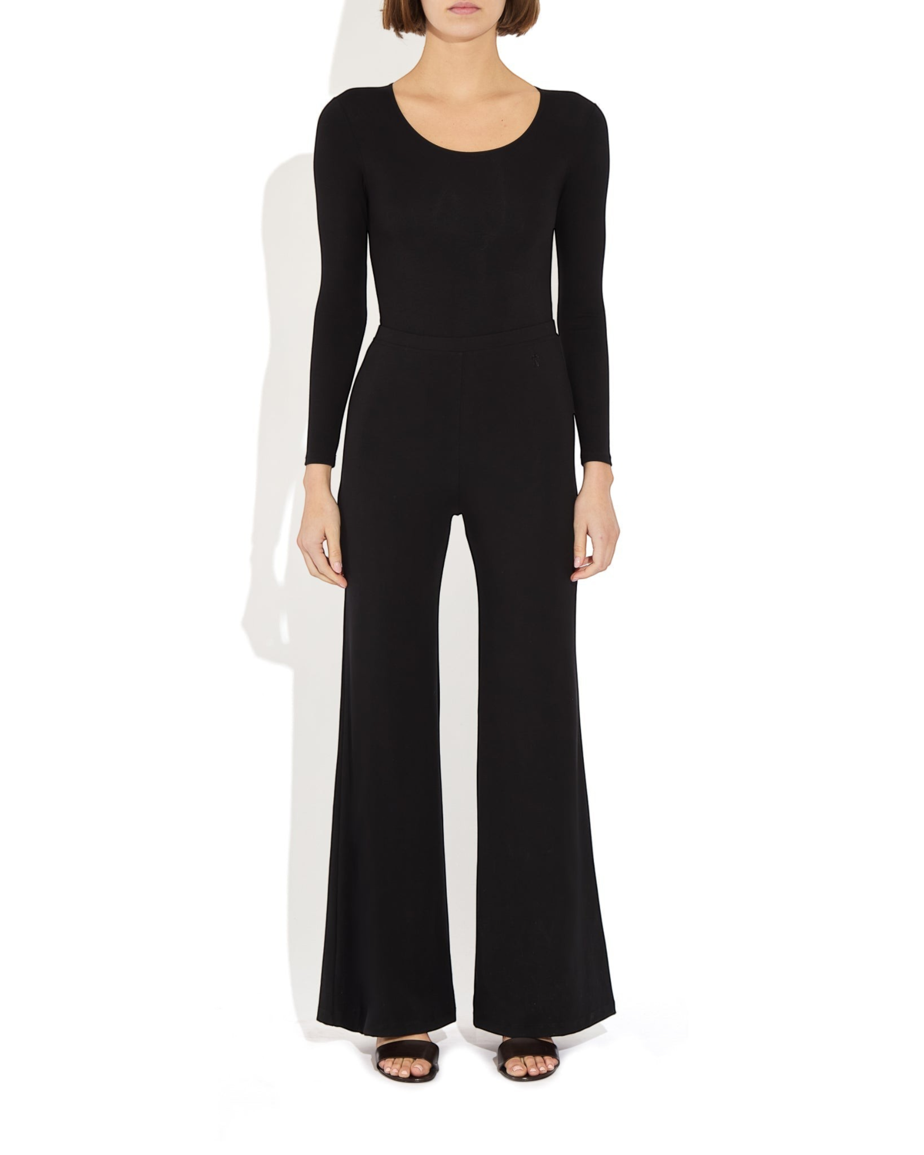 Weldun Donna long-sleeve black scoop neck bodysuit in soft stretch-knit fabric worn with matching wide-leg trousers