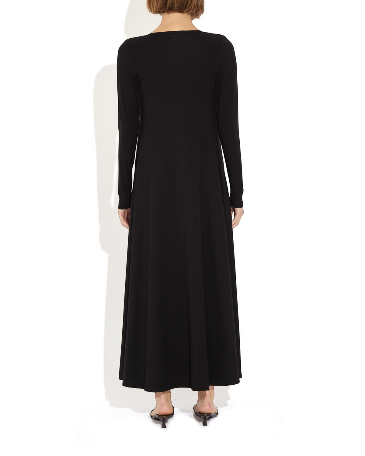 Back view of a model wearing the black Weldun Julia Cardigan, a long, fluid, open-front piece in soft MicroTencel.
