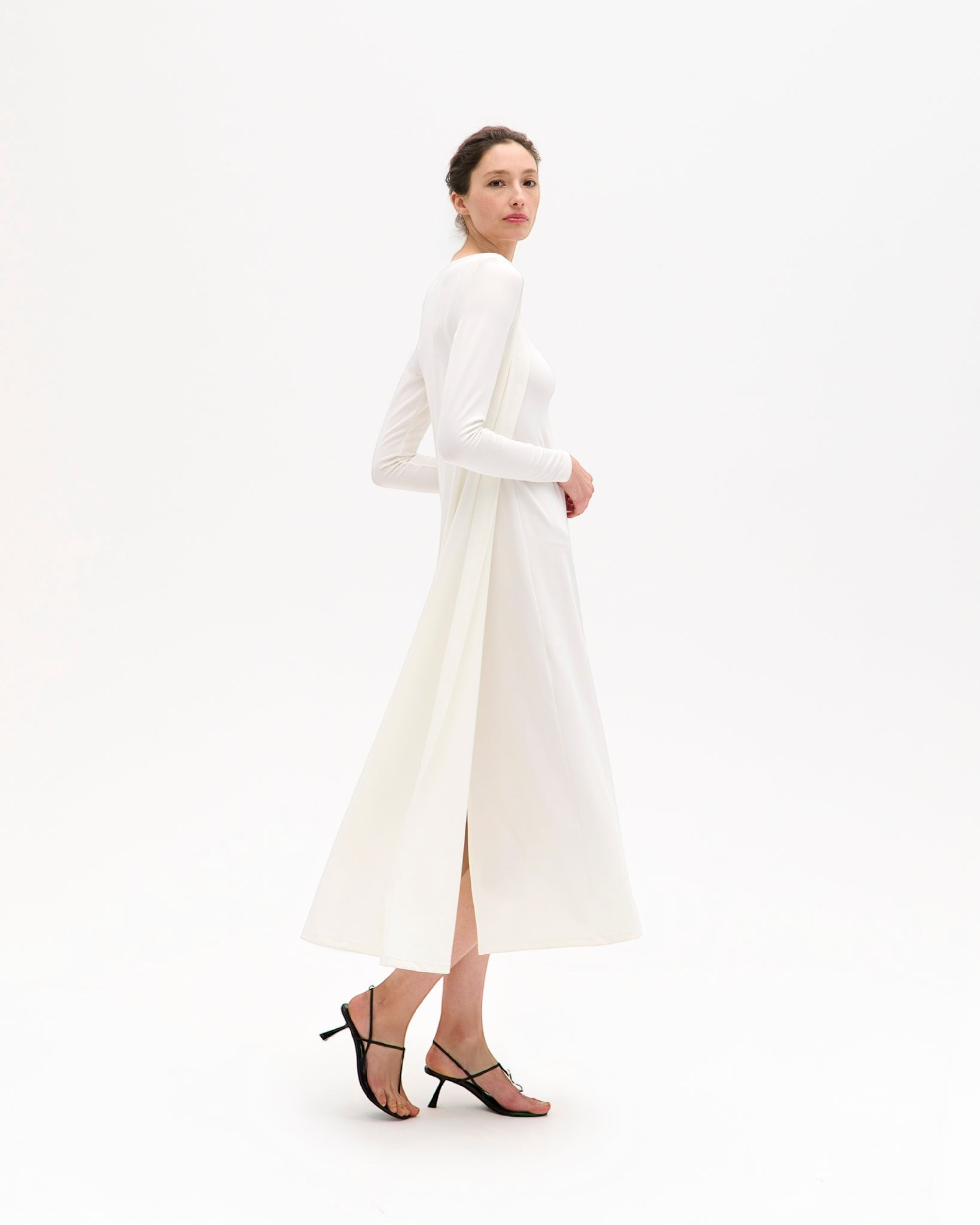 Model wearing a long white Weldun Julia Cardigan in soft stretch PYRATEX fabric with an open-front fluid silhouette.