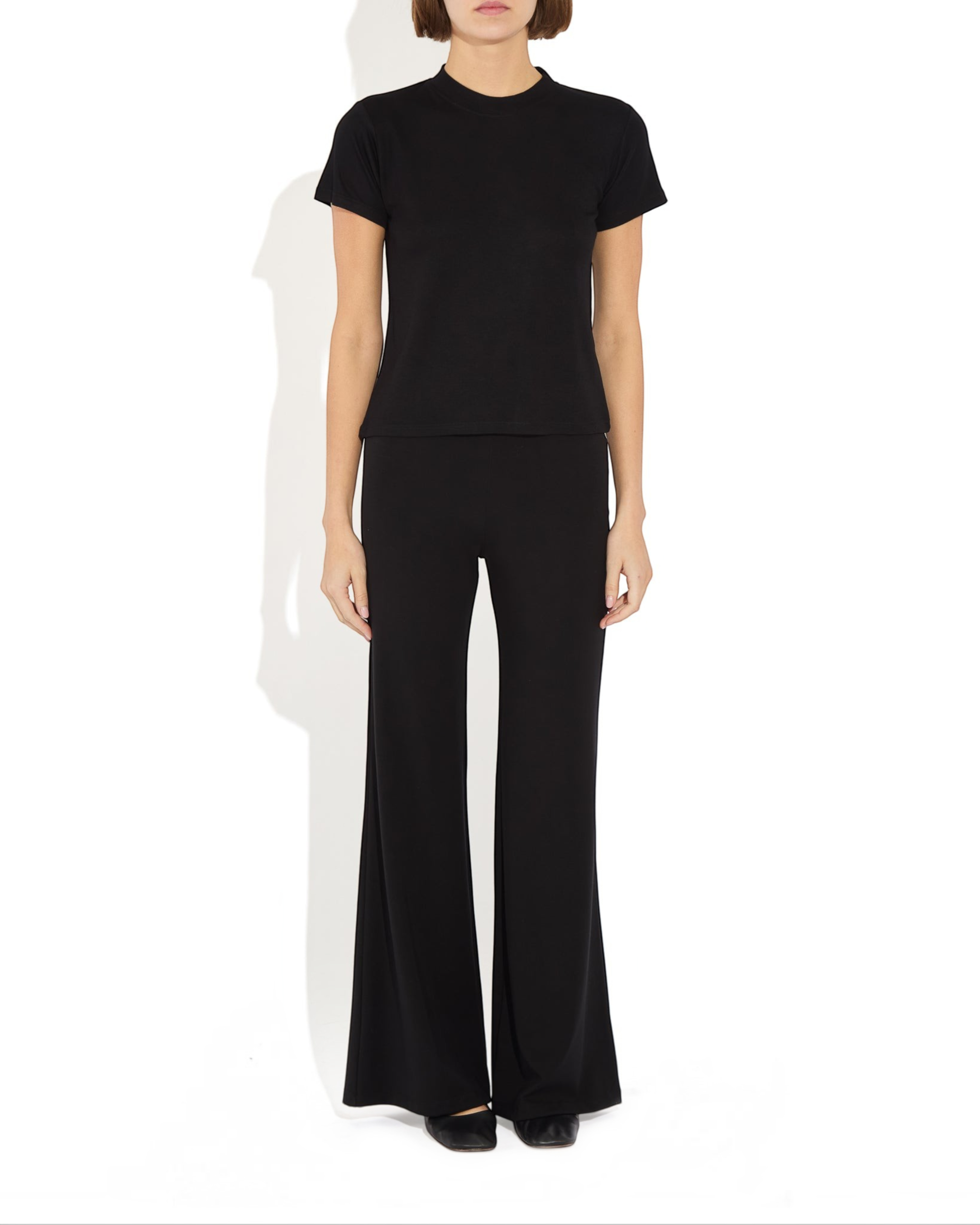 Weldun Tessa Long Pant in black, featuring a high elasticated waist and fluid flare leg in soft, breathable fabric.