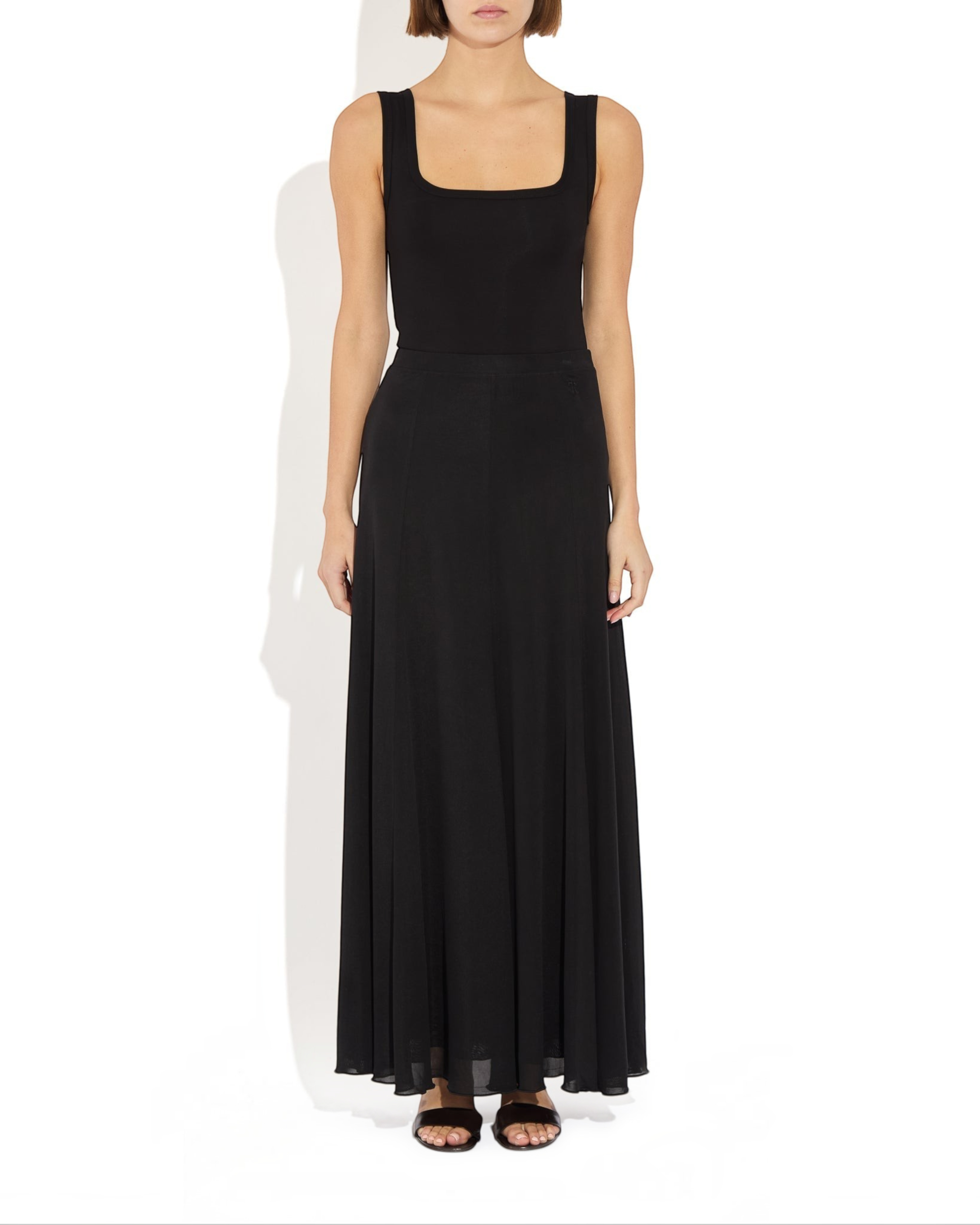 Weldun black semi-sheer Olivia maxi skirt in soft lyocell with a fluid paneled design and comfortable elastic waist.