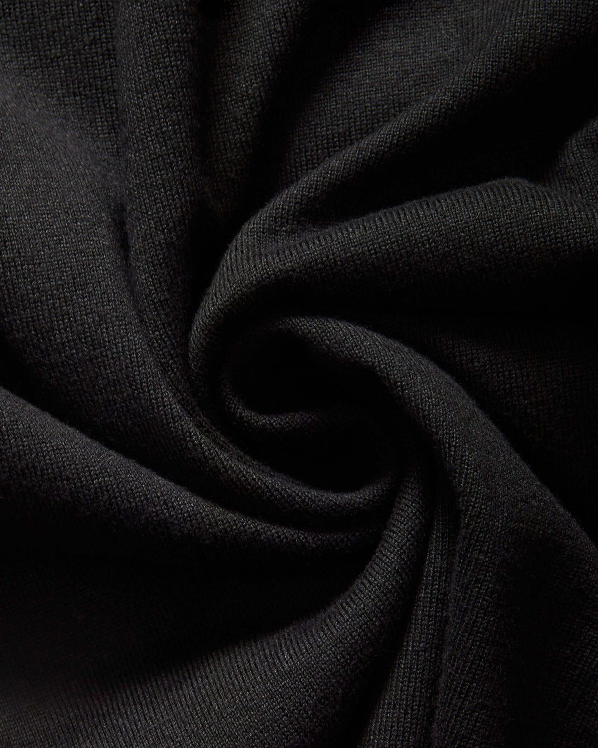 Weldun black knit fabric texture of the MagnaReady adaptive cardigan sweater showing soft rayon and nylon blend