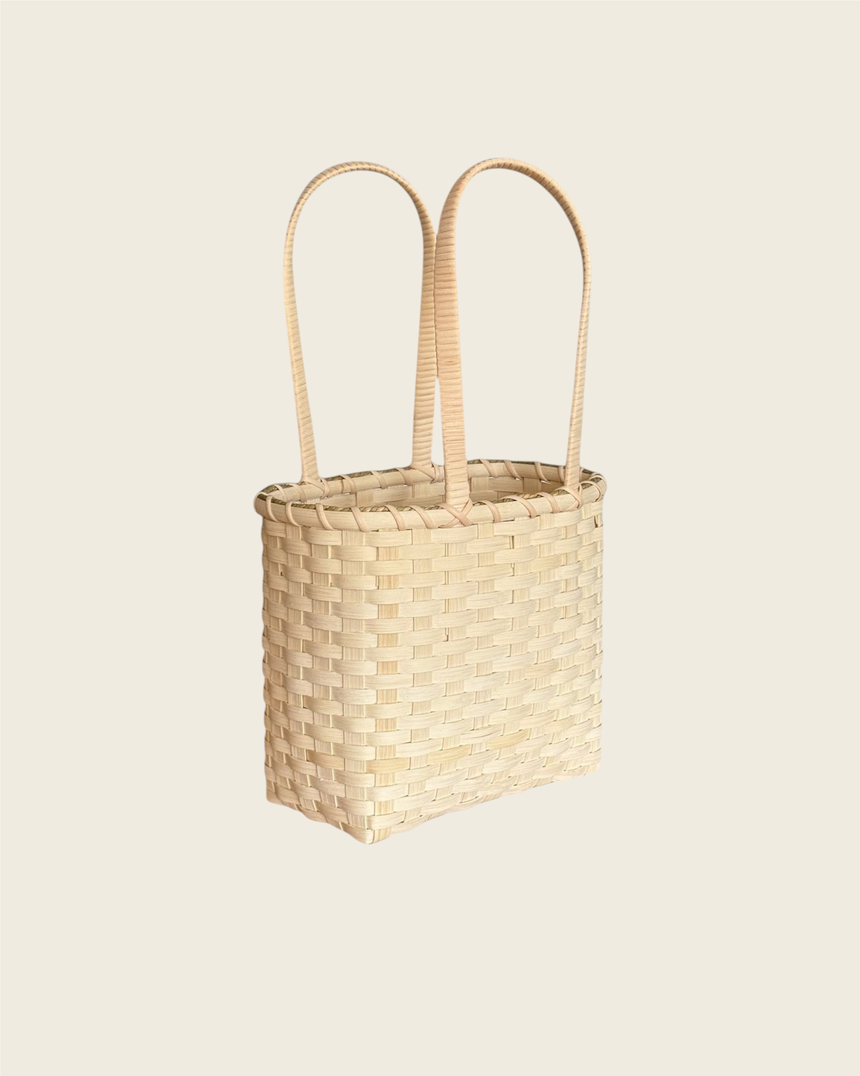 Weldun Carol Lunch Basket hand-woven from natural rattan with long shoulder straps for hands-free carrying.