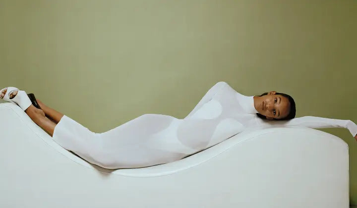 Woman in a white dress on a sofa 