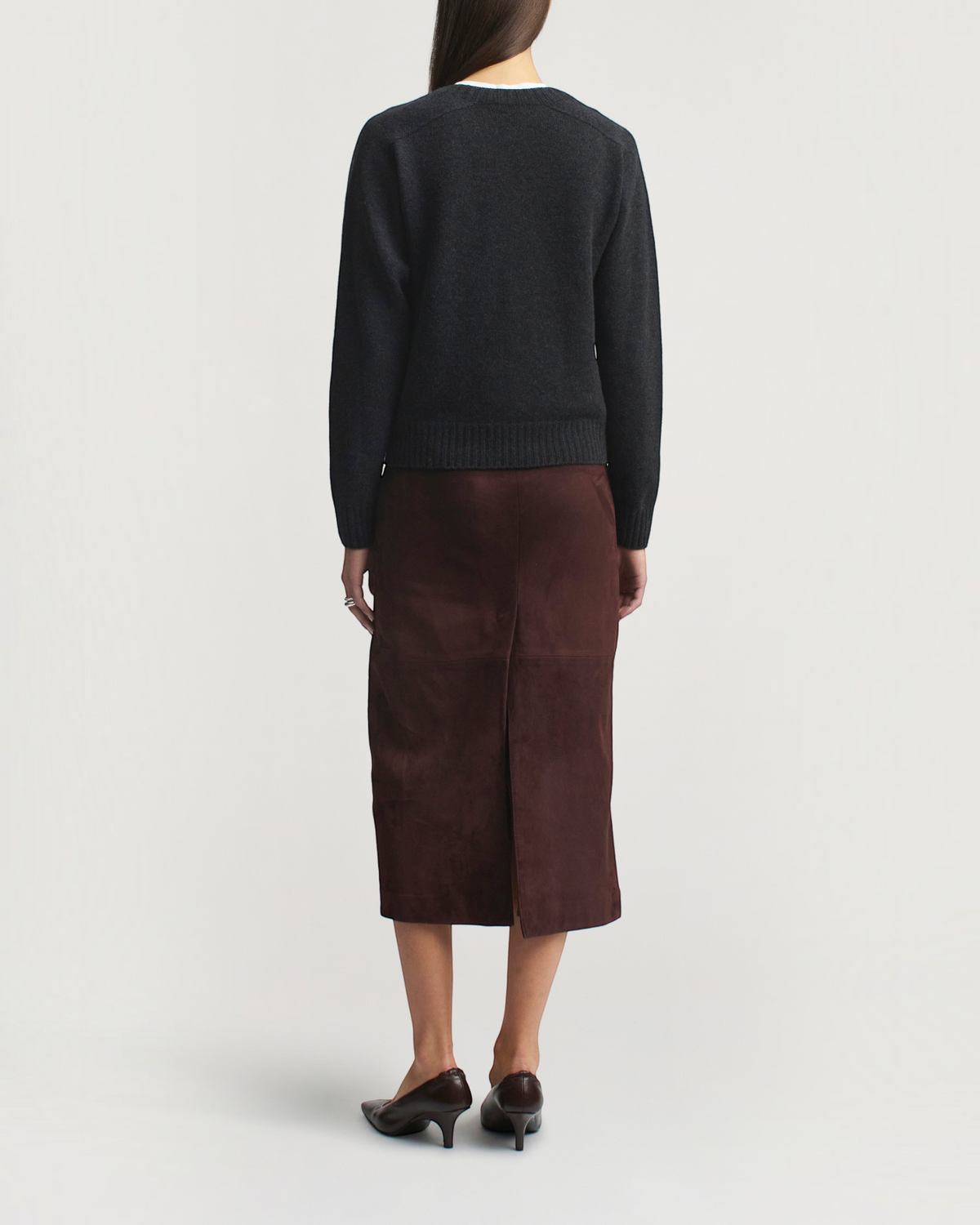 Weldun KALLMEYER Nina seamless crewneck in charcoal wool cashmere paired with a brown suede midi skirt, back view.