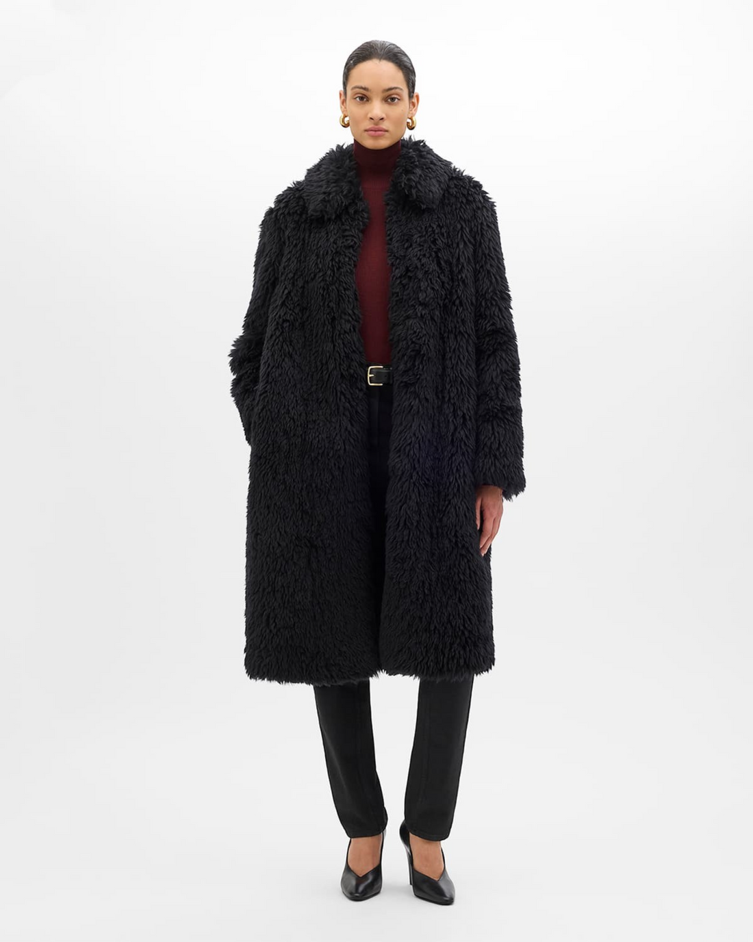 Weldun black faux fur Balmacaan coat with a relaxed fit, point collar, and frog closures on a model.