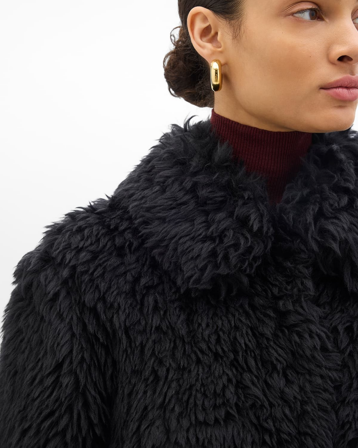 Weldun black faux fur Balmacaan coat with a point collar and textured wool-like finish worn by a model