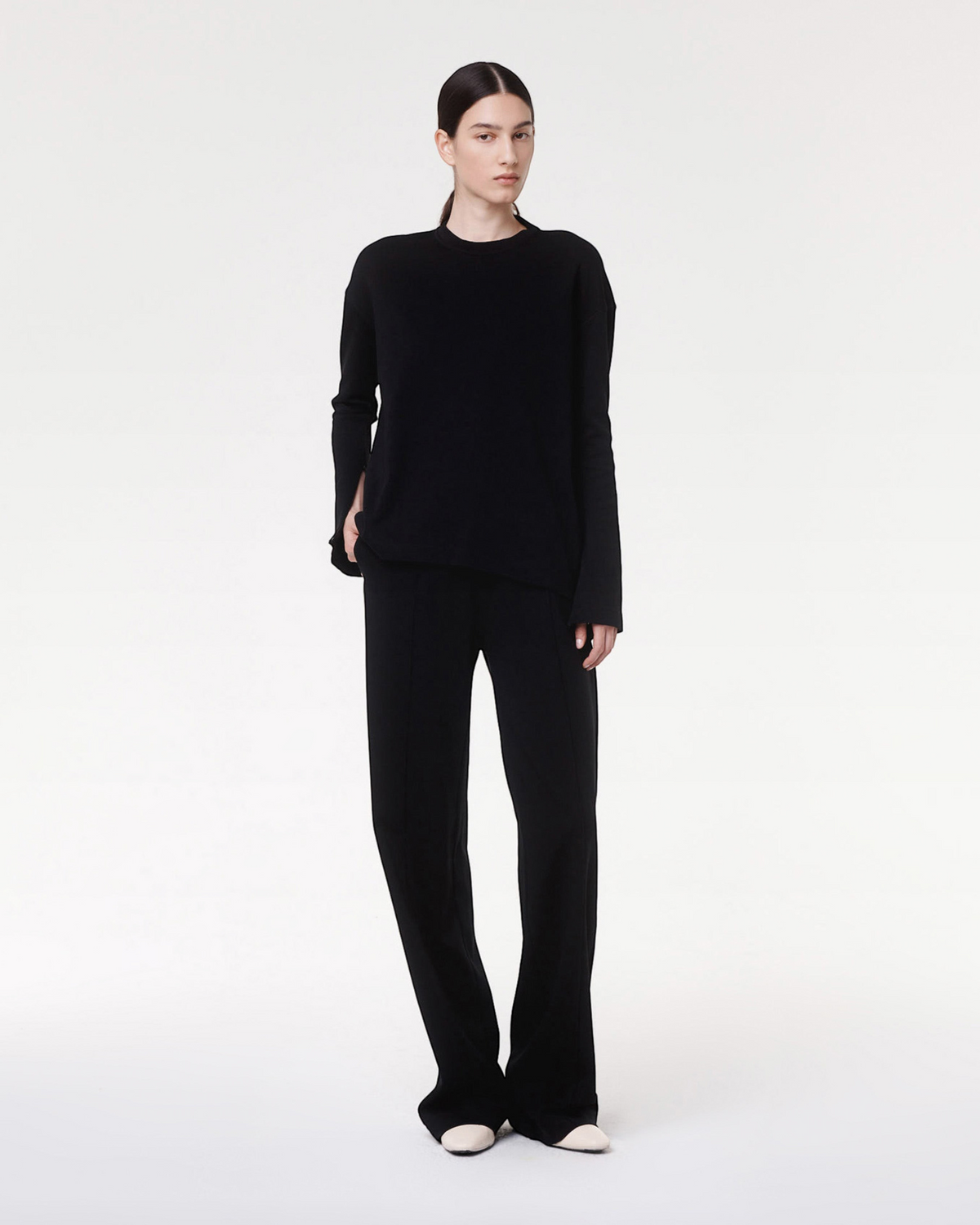 Model wearing Weldun Luxe Seamed Lounge Pant in black with pintuck details and elastic waistband