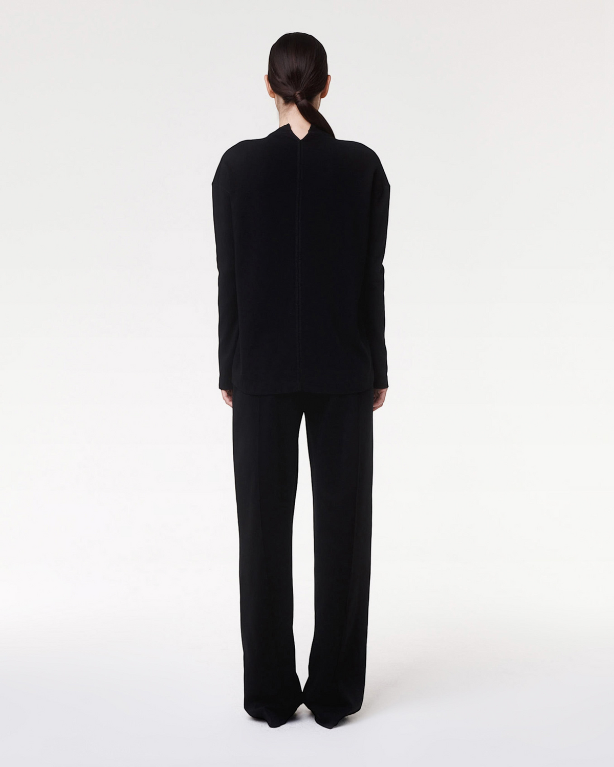 Weldun Luxe Seamed Lounge Pant in black worn by a model, showing the back view of the straight-leg relaxed fit.