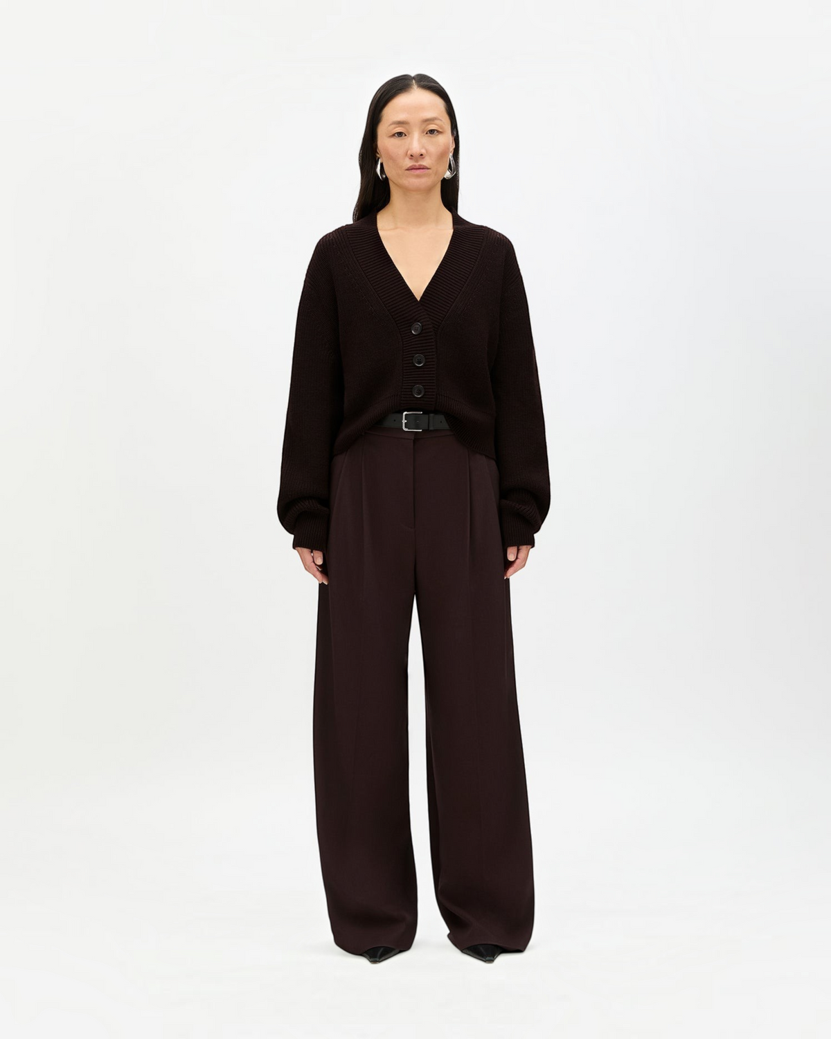 Weldun model wearing a chocolate brown ribbed cropped cardigan with front buttons and dropped shoulders.