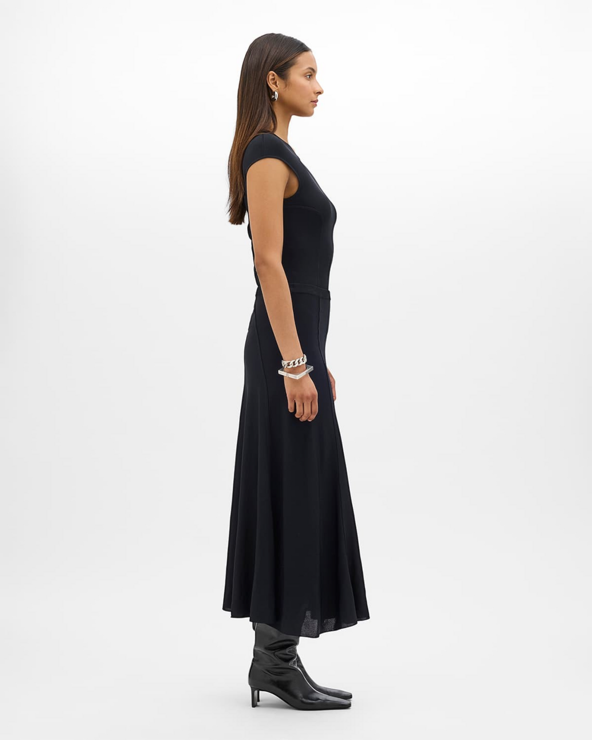 Weldun black seamed fitted jersey top worn by a model in a side profile view, paired with a matching skirt.