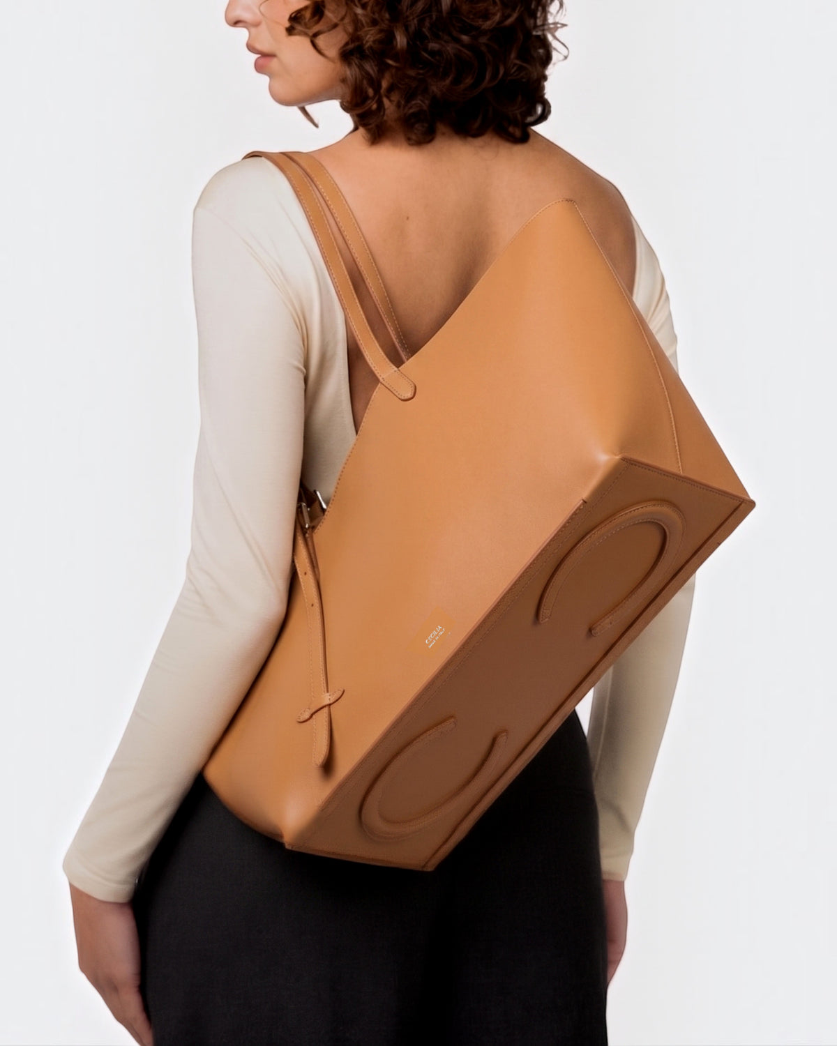 Weldun Leonora Day soft tan Italian nappa leather tote bag with adjustable stirrup buckle straps worn on shoulder