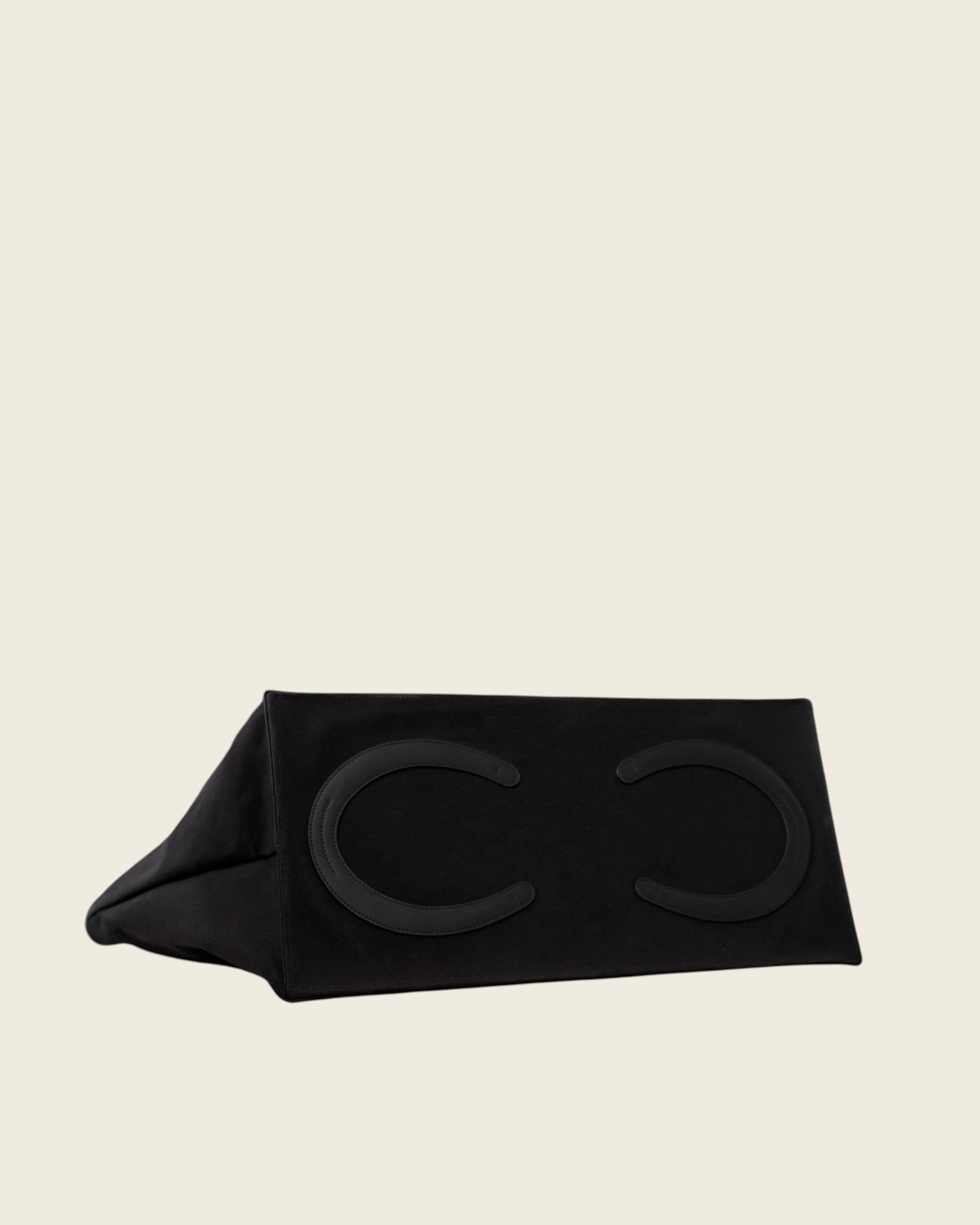 Weldun Leonora Weekend Canvas Carryall in black featuring leather horseshoe feet on the base of the bag.