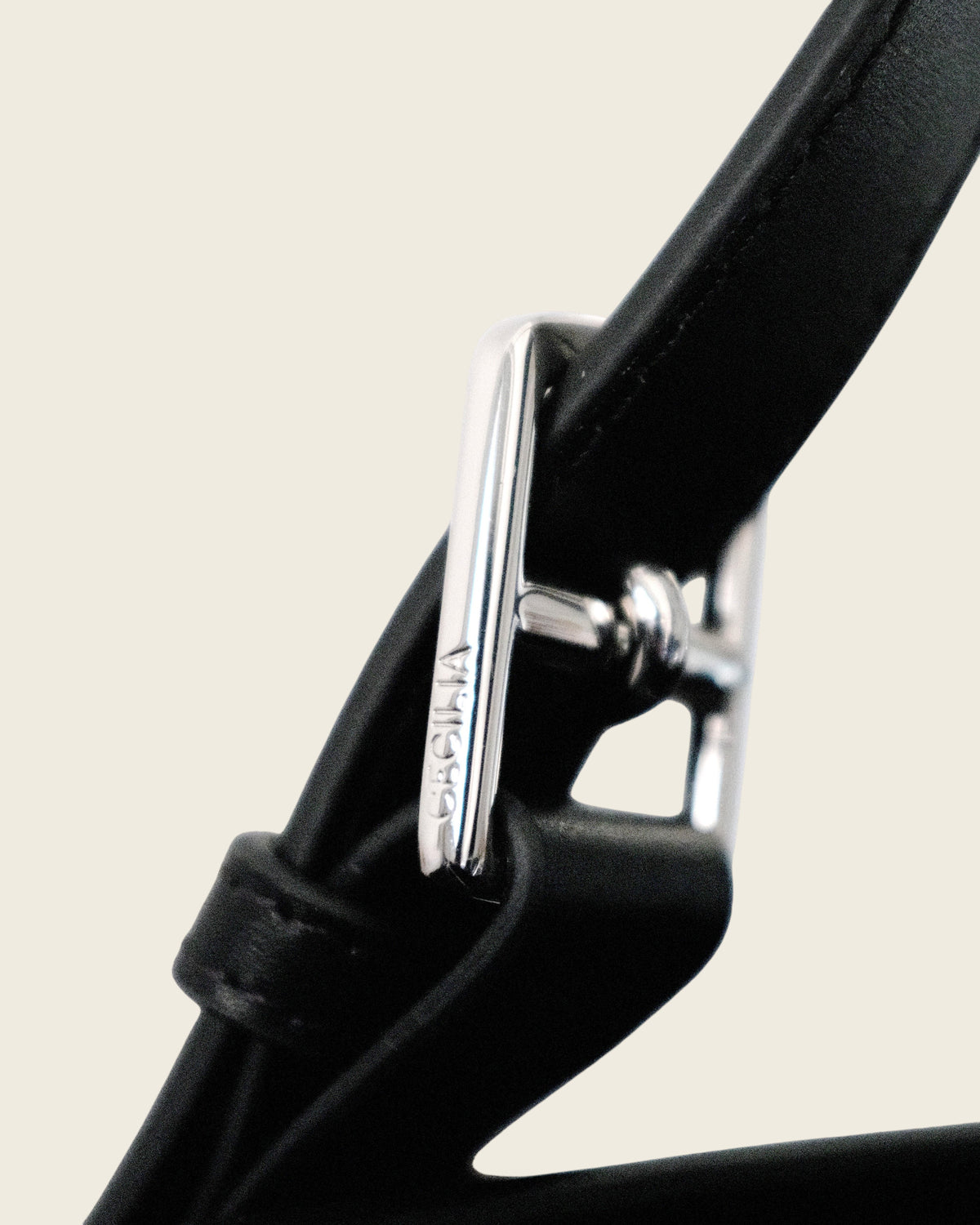 Close-up of silver custom hardware buckle on a Weldun Leonora Weekend Canvas Carryall black leather strap