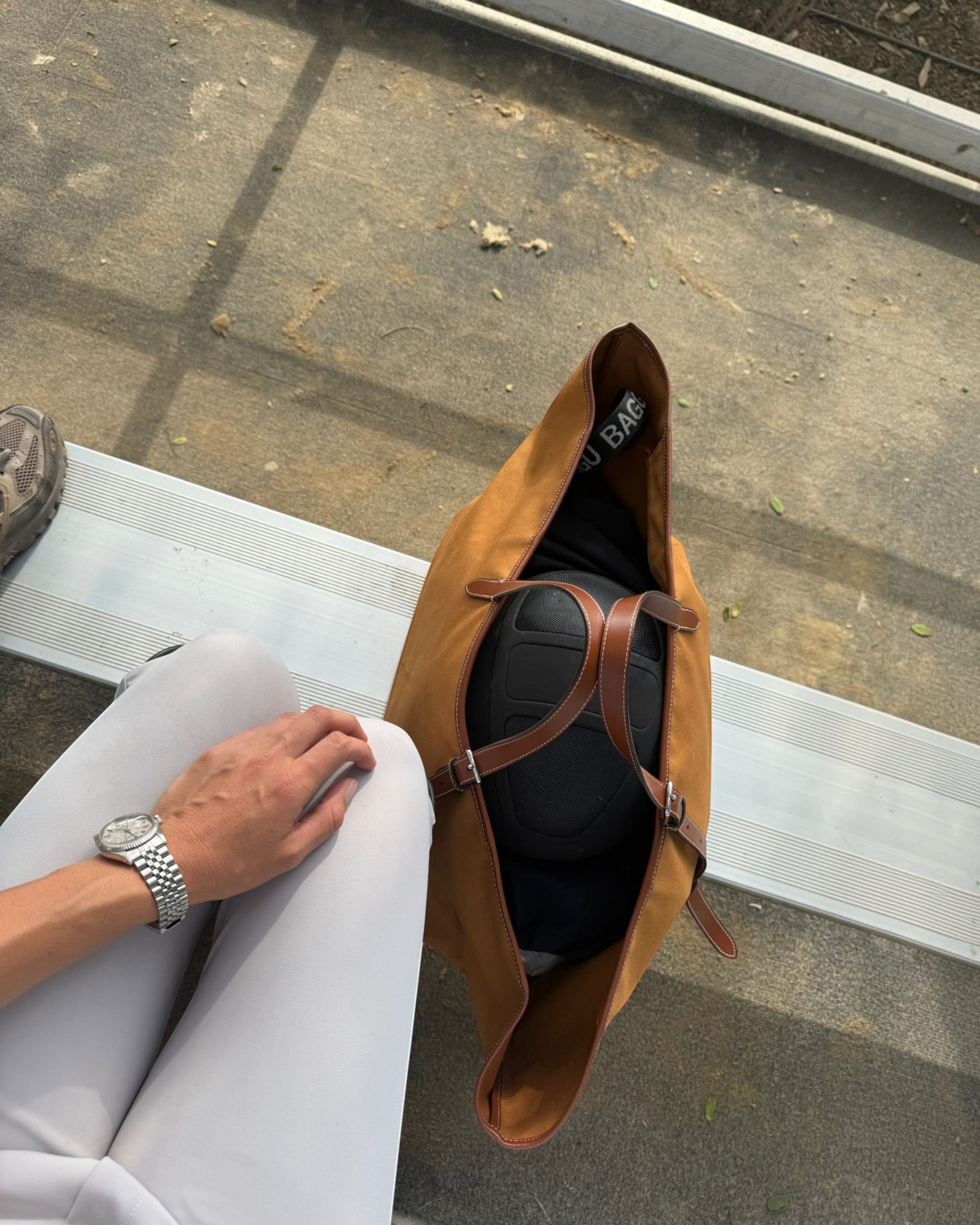 Weldun Leonora Weekend Canvas Carryall in tan with brown leather trim, shown from above on a bench.
