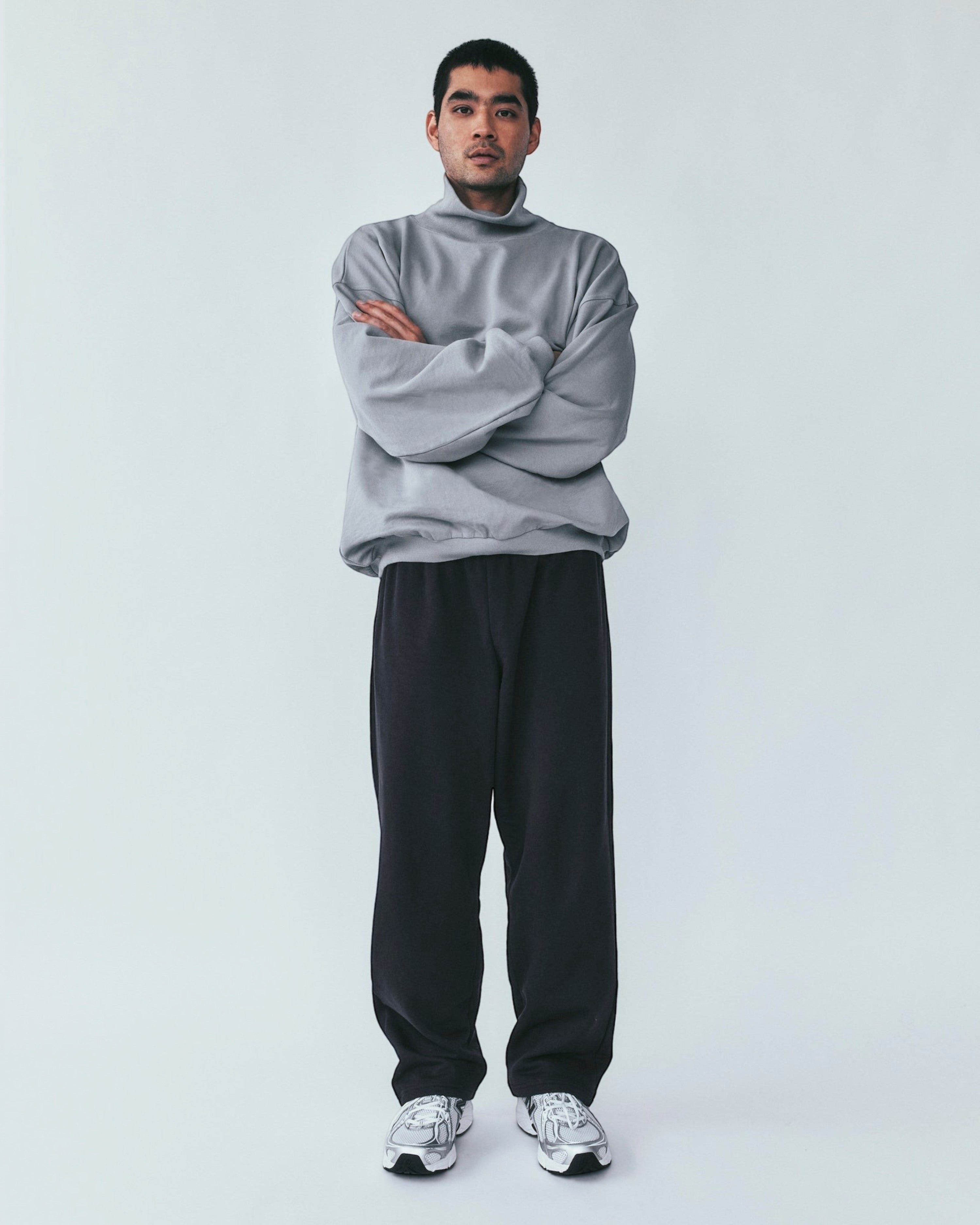 Weldun grey organic cotton high neck sweatshirt with a boxy fit worn by a man with arms crossed