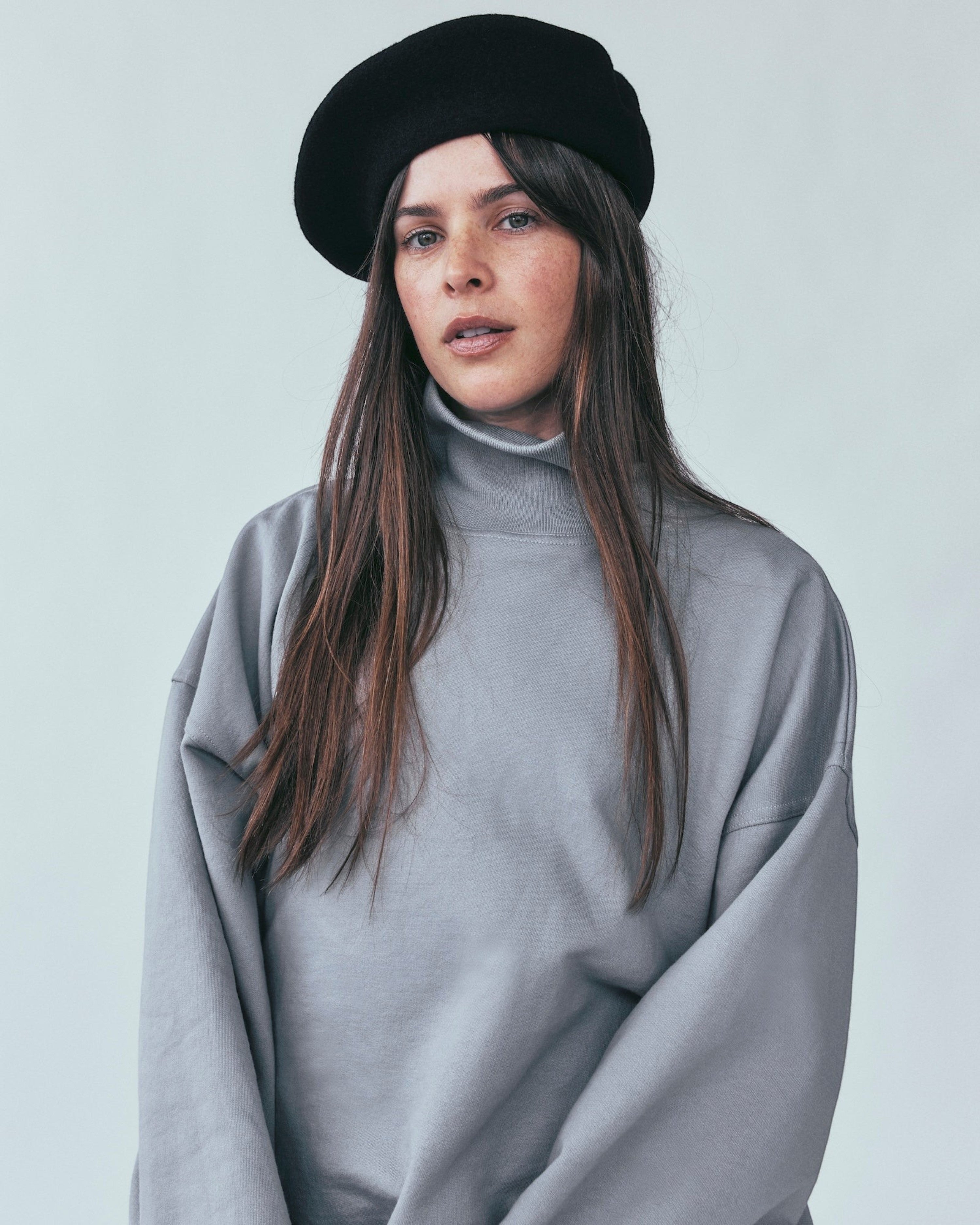 Weldun grey organic cotton high neck sweatshirt with a boxy fit worn by a woman in a black beret
