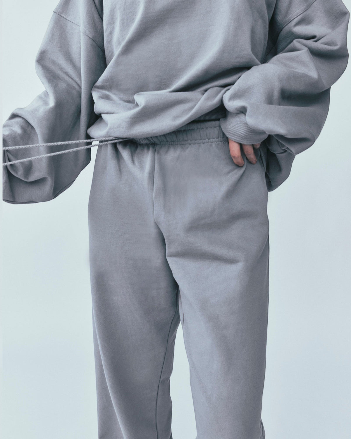 Weldun grey organic cotton sweatpants with a relaxed straight-leg fit, elastic waistband, and adjustable drawstring.