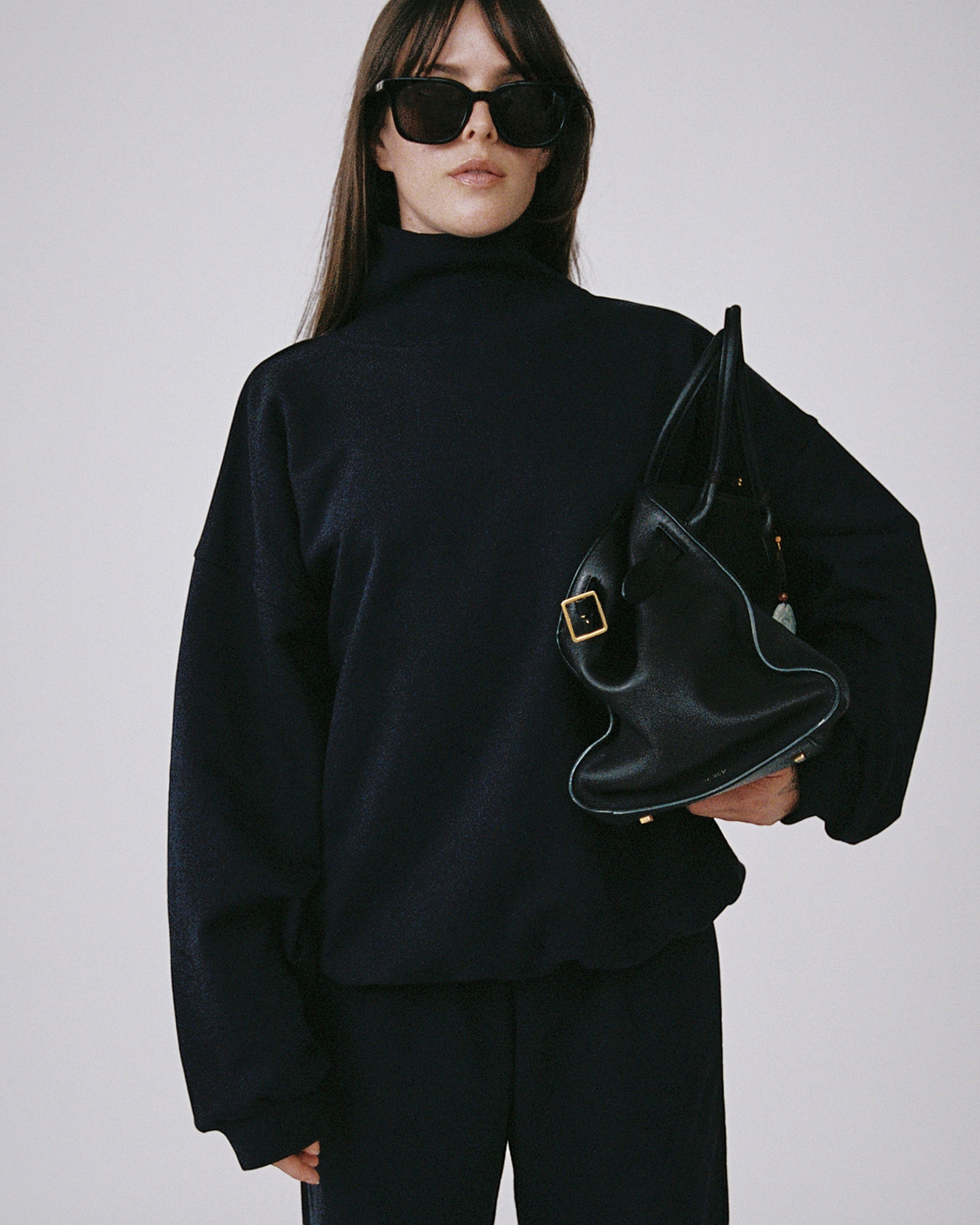 Weldun navy organic cotton high neck sweatshirt with a relaxed boxy fit worn by a model with black sunglasses