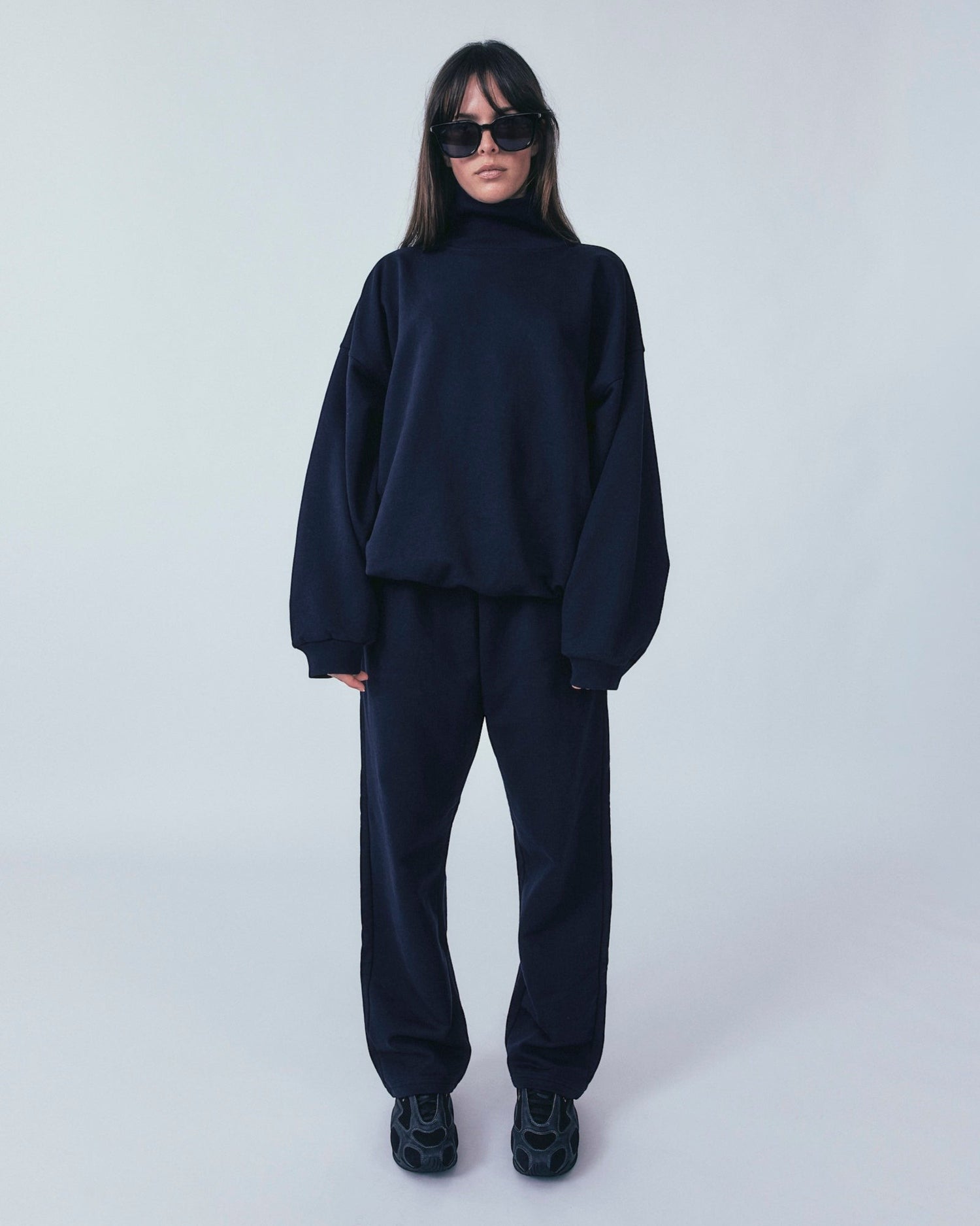 Weldun navy organic cotton sweatpants with a relaxed straight-leg fit and adjustable waistband on a model