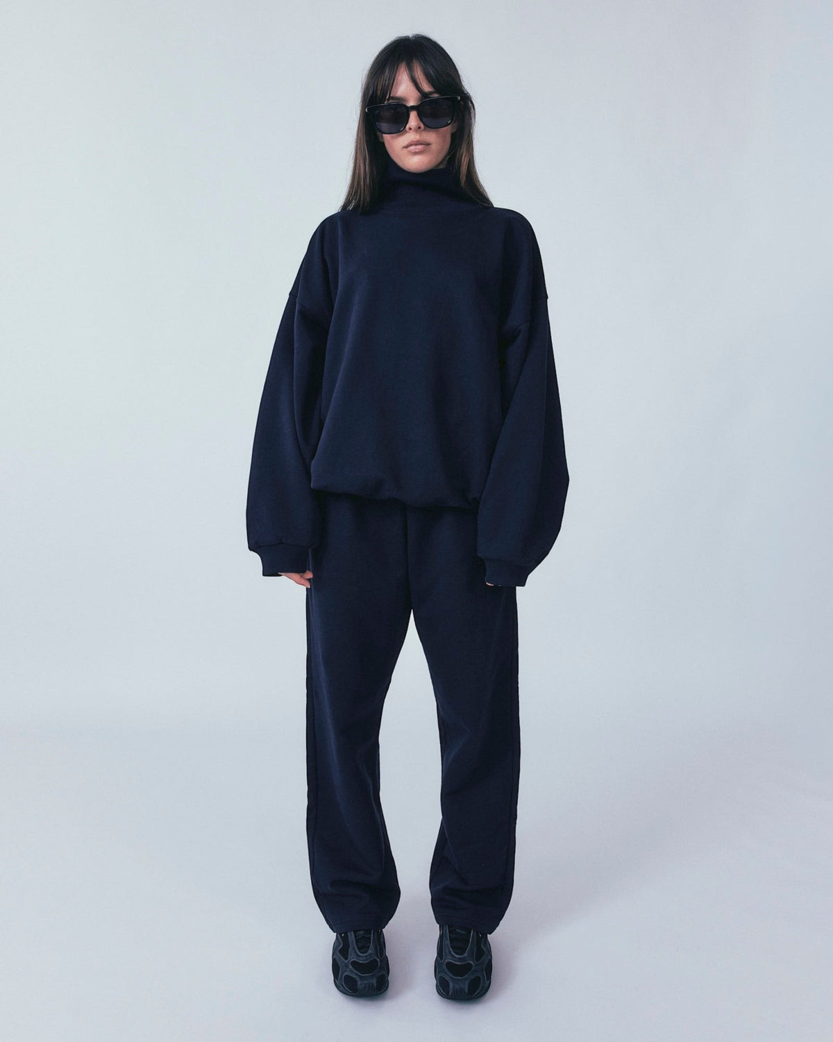 Weldun navy organic cotton sweatpants with a relaxed straight-leg fit and adjustable waistband on a model