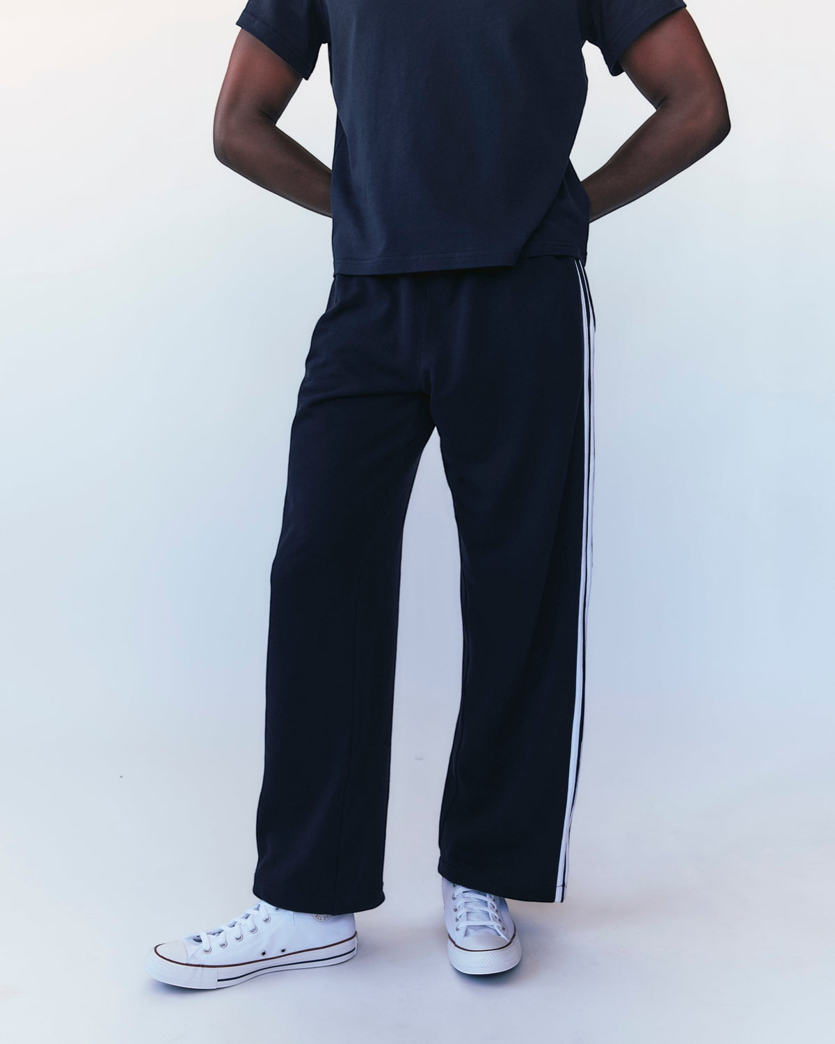 Weldun navy cotton terry track pants with white side stripes worn by a model in a relaxed fit