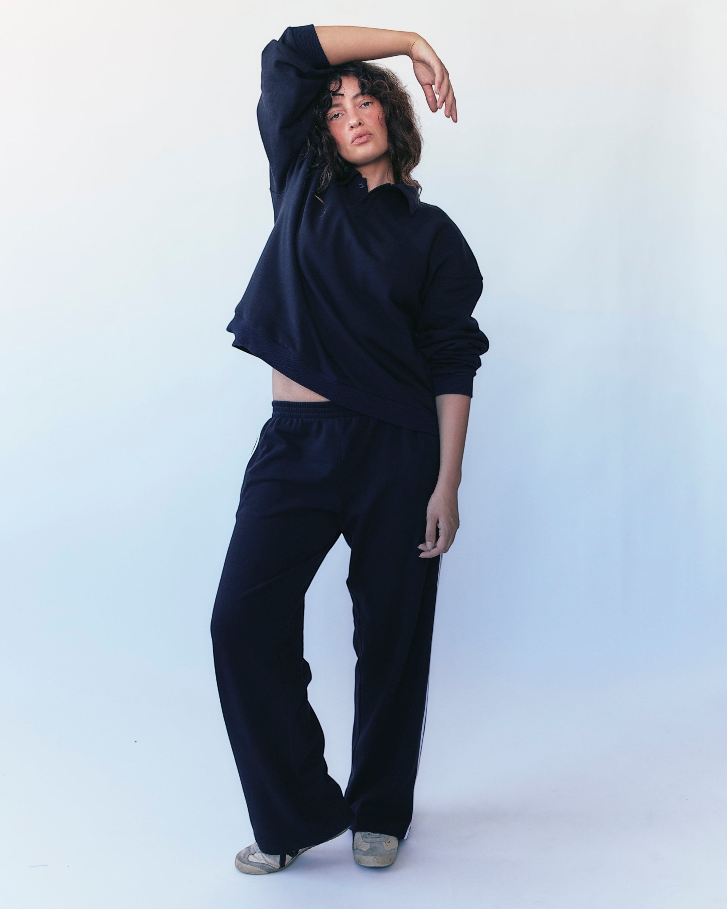 Weldun navy polo sweatshirt with oversized boxy fit and ribbed collar worn by a model with matching sweatpants