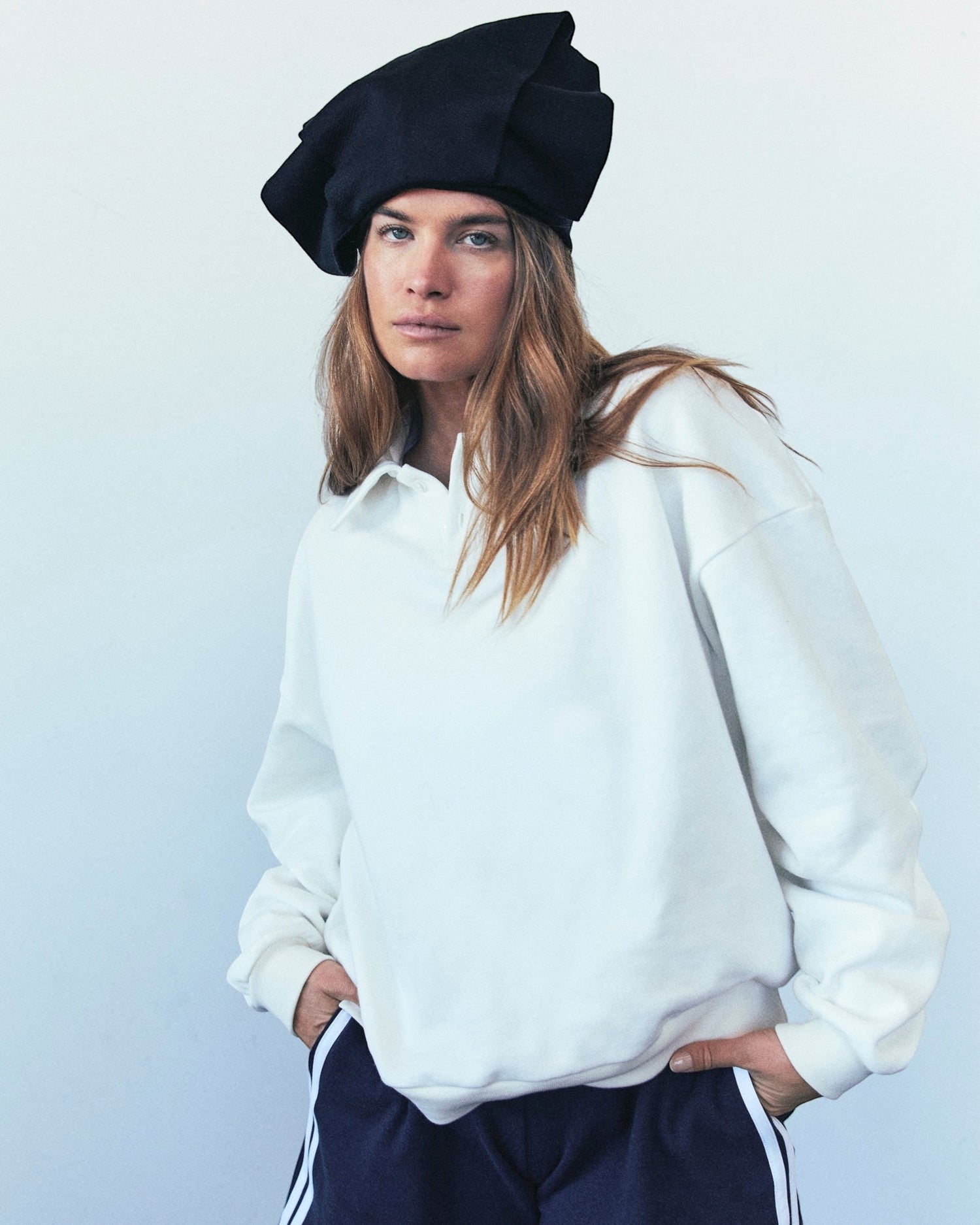 Weldun H-O-R-S-E white oversized cotton polo sweatshirt with ribbed collar and placket worn by a model in a beret