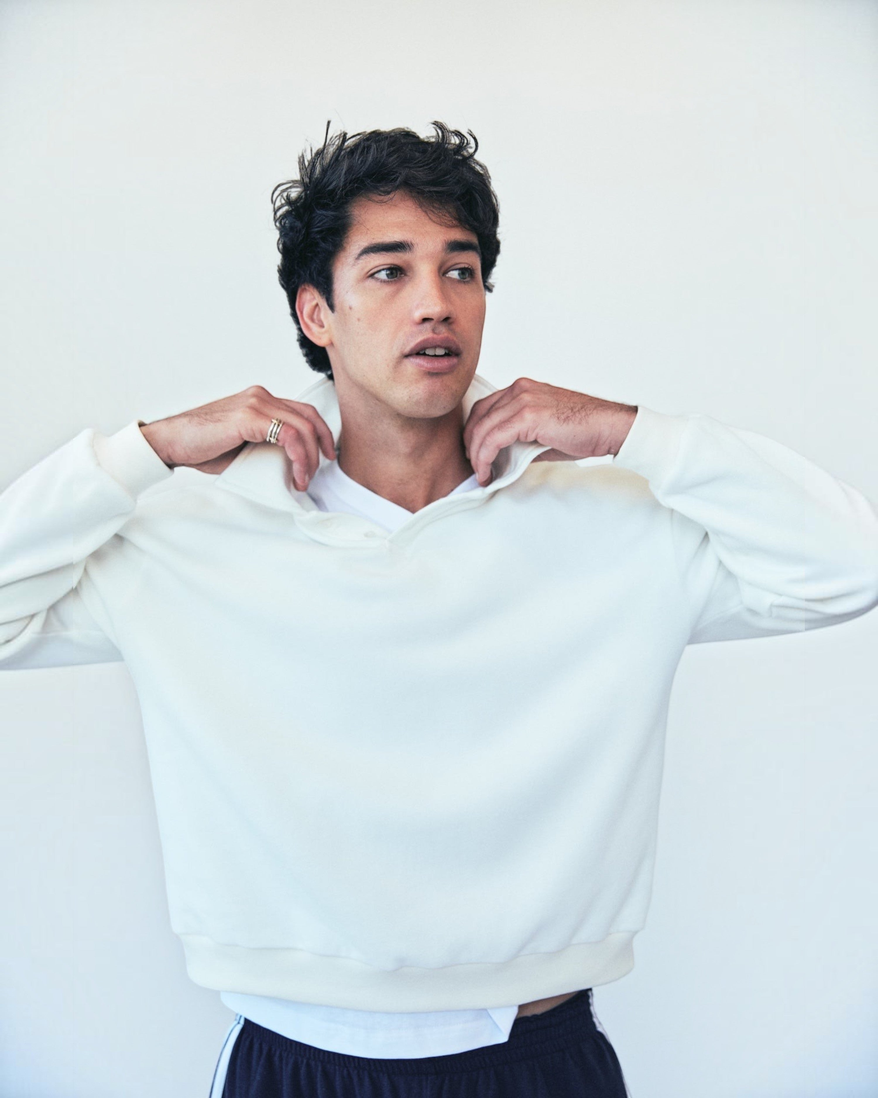 Weldun white oversized cotton polo sweatshirt with a high ribbed collar worn by a man against a plain background