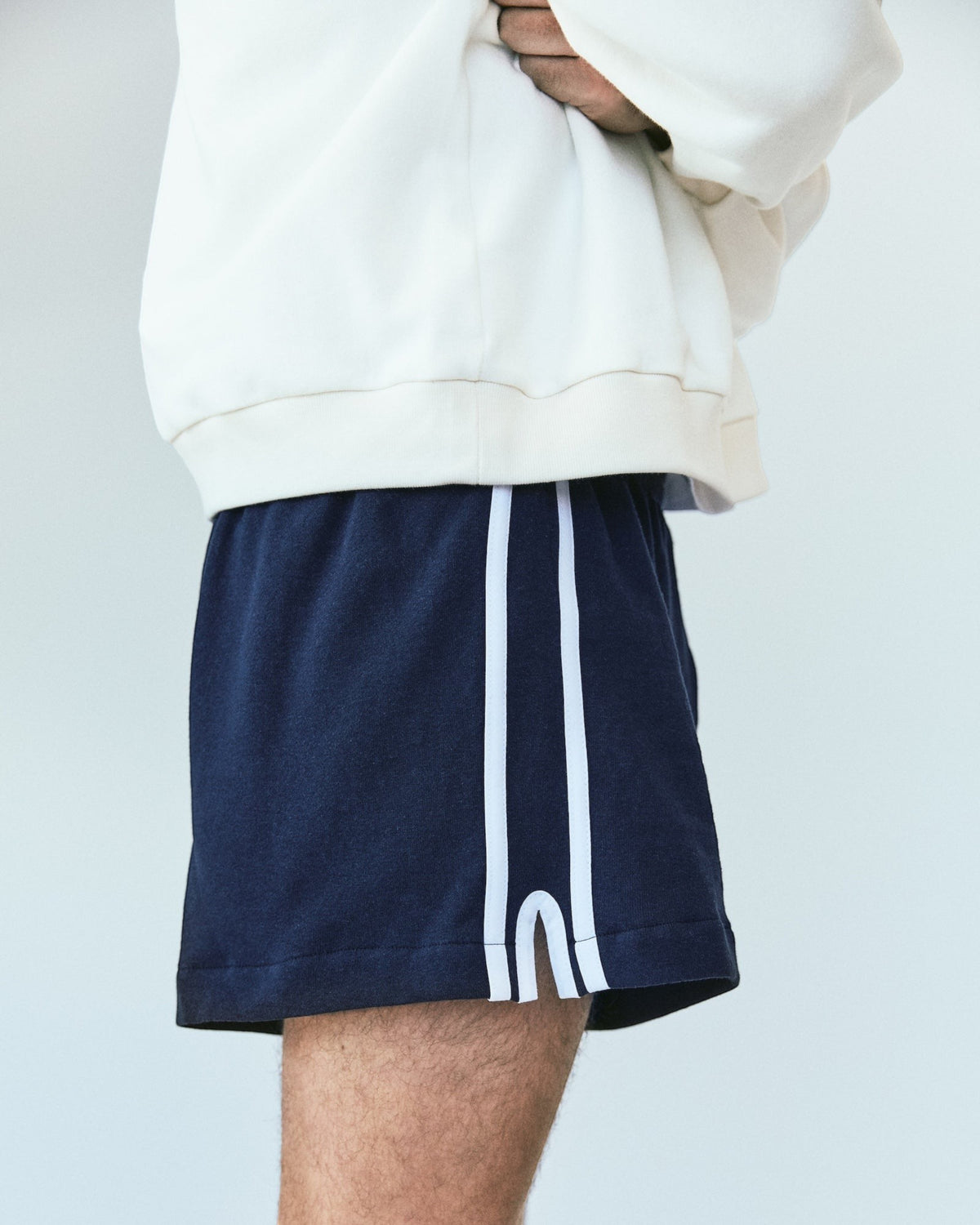 Weldun navy blue Japanese cotton terry basketball shorts with white side stripes and an elastic waistband.