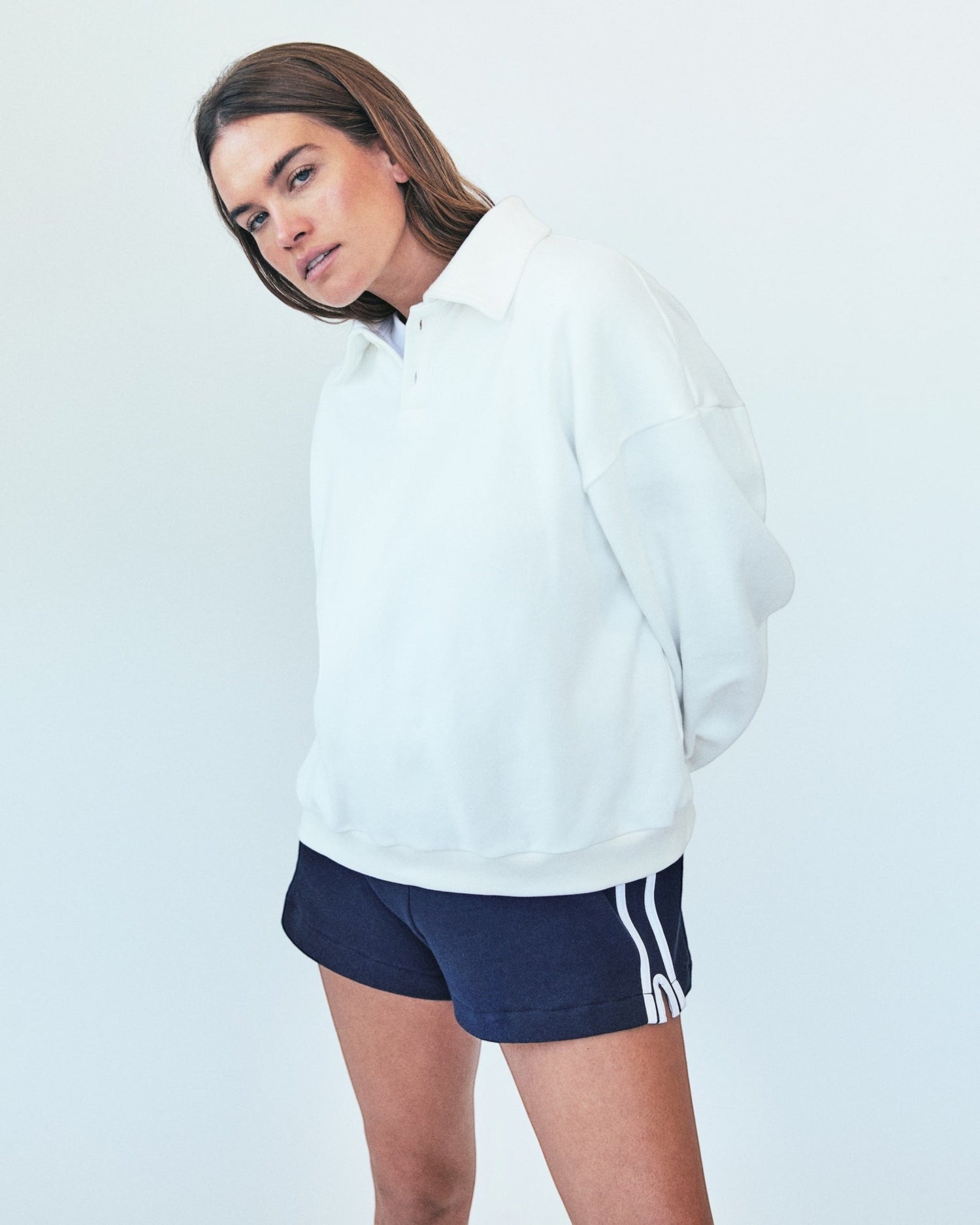 Weldun model wearing navy blue H-O-R-S-E cotton terry basketball shorts with white side stripes and elastic waist.