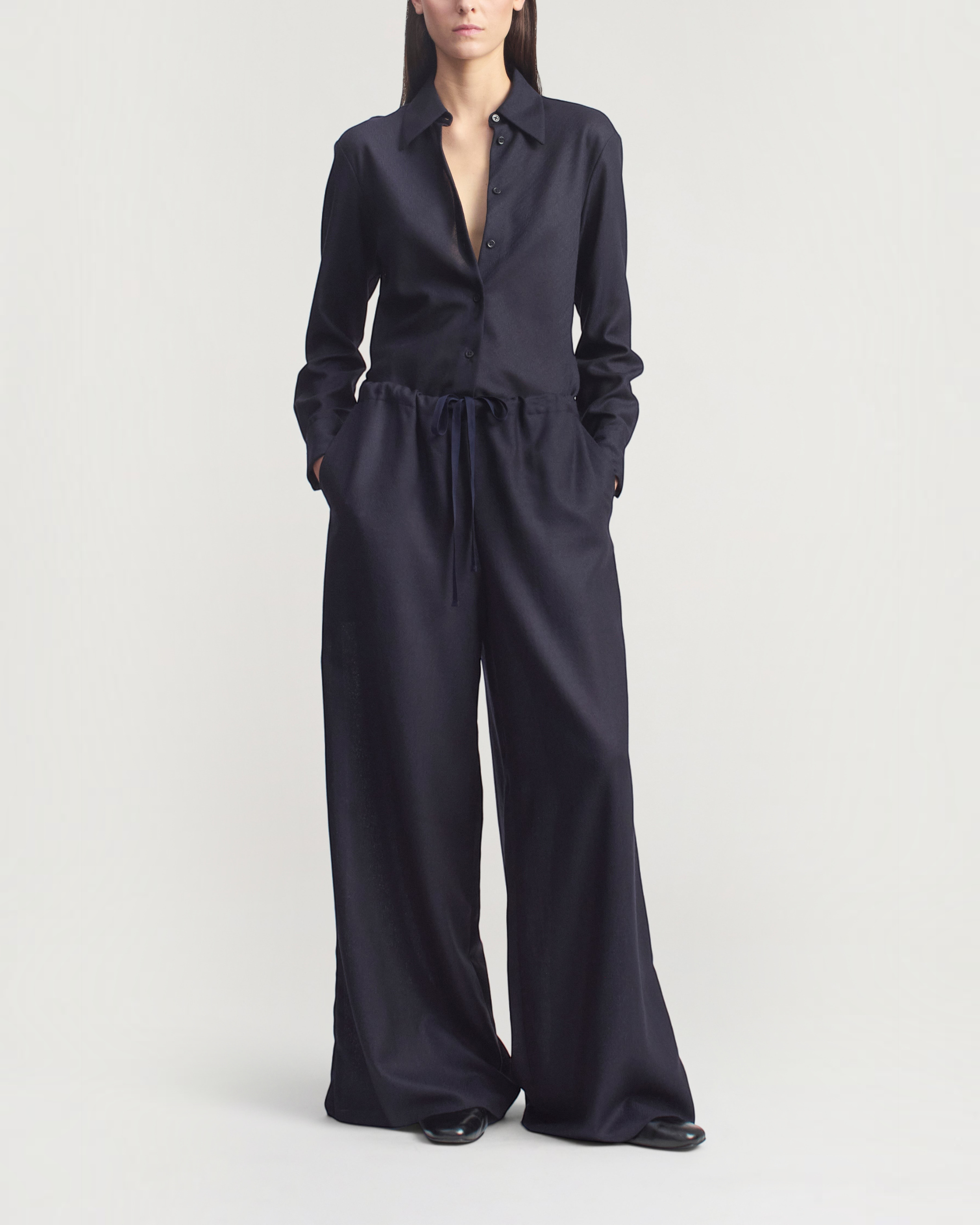 Model wearing Weldun KALLMEYER Cairo wide leg indigo pants in featherweight wool with an adjustable drawstring waist.