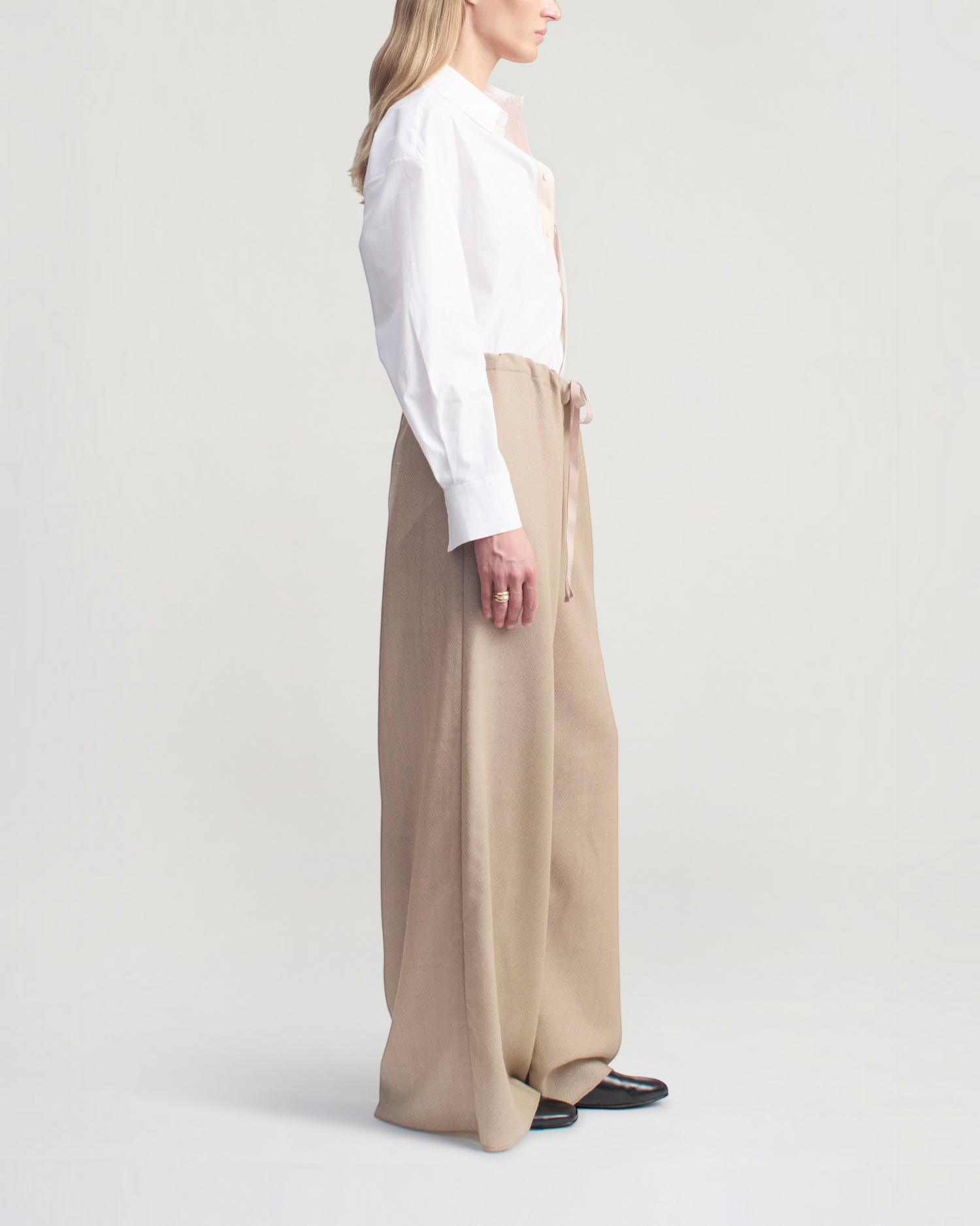 Weldun Cairo wide leg pants in taupe featherweight wool with an adjustable drawstring waist, side view on a model.