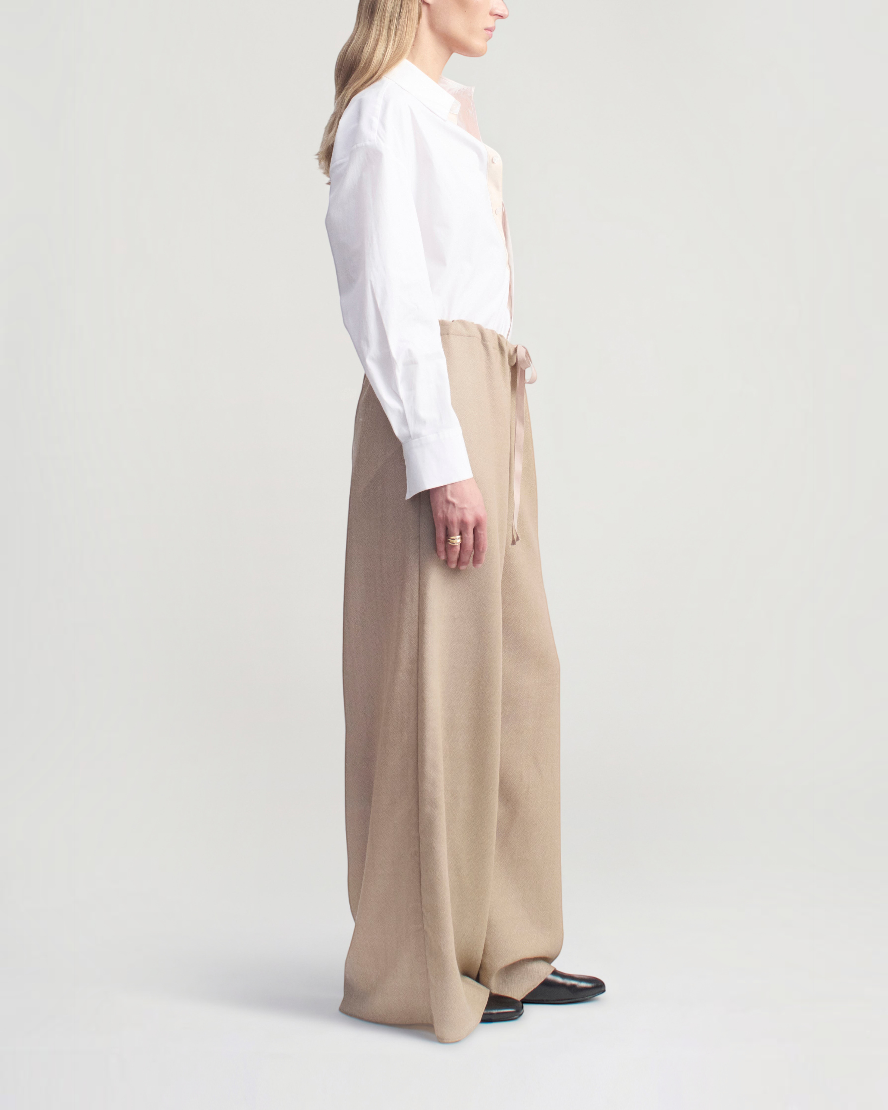 Weldun Cairo wide leg pants in taupe featherweight wool with an adjustable drawstring waist, side view on a model.