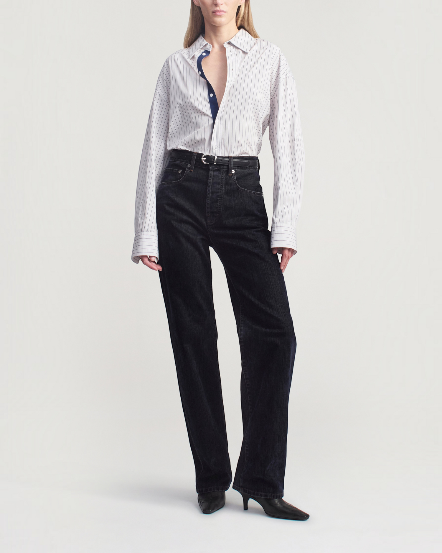 Weldun Dani button down shirt in navy stripe cotton poplin with a tonal grosgrain placket worn with black jeans.